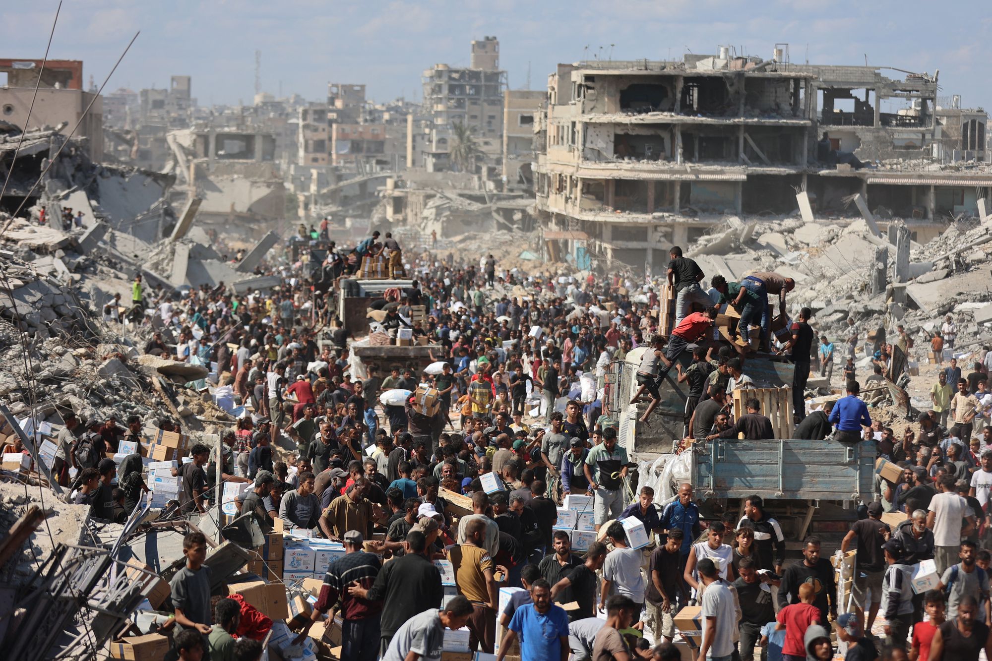 Palestinians rally around aid trucks in Khan Younis on Sunday