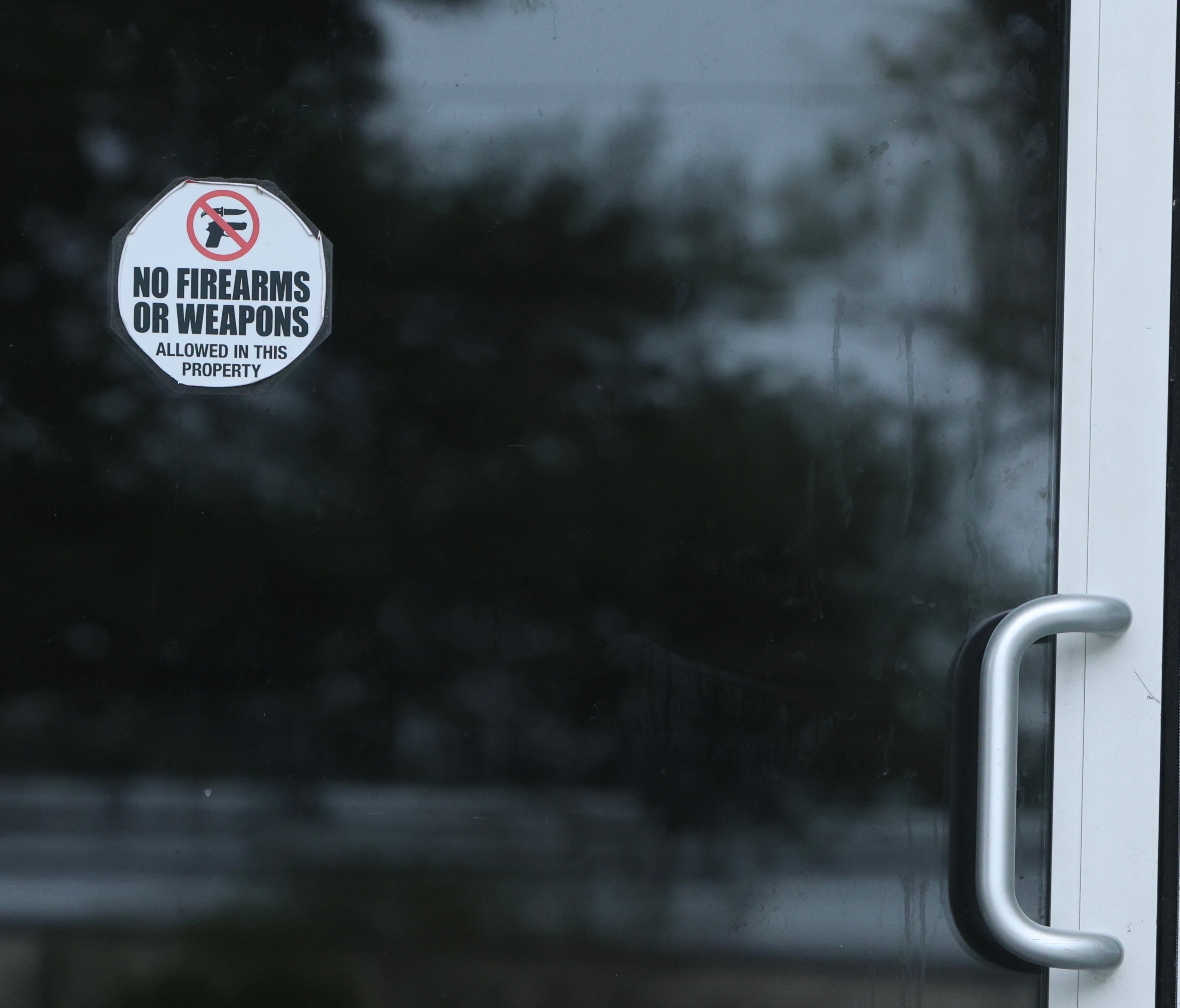 A sticker on the door of the bar said no weapons were allowed on site.