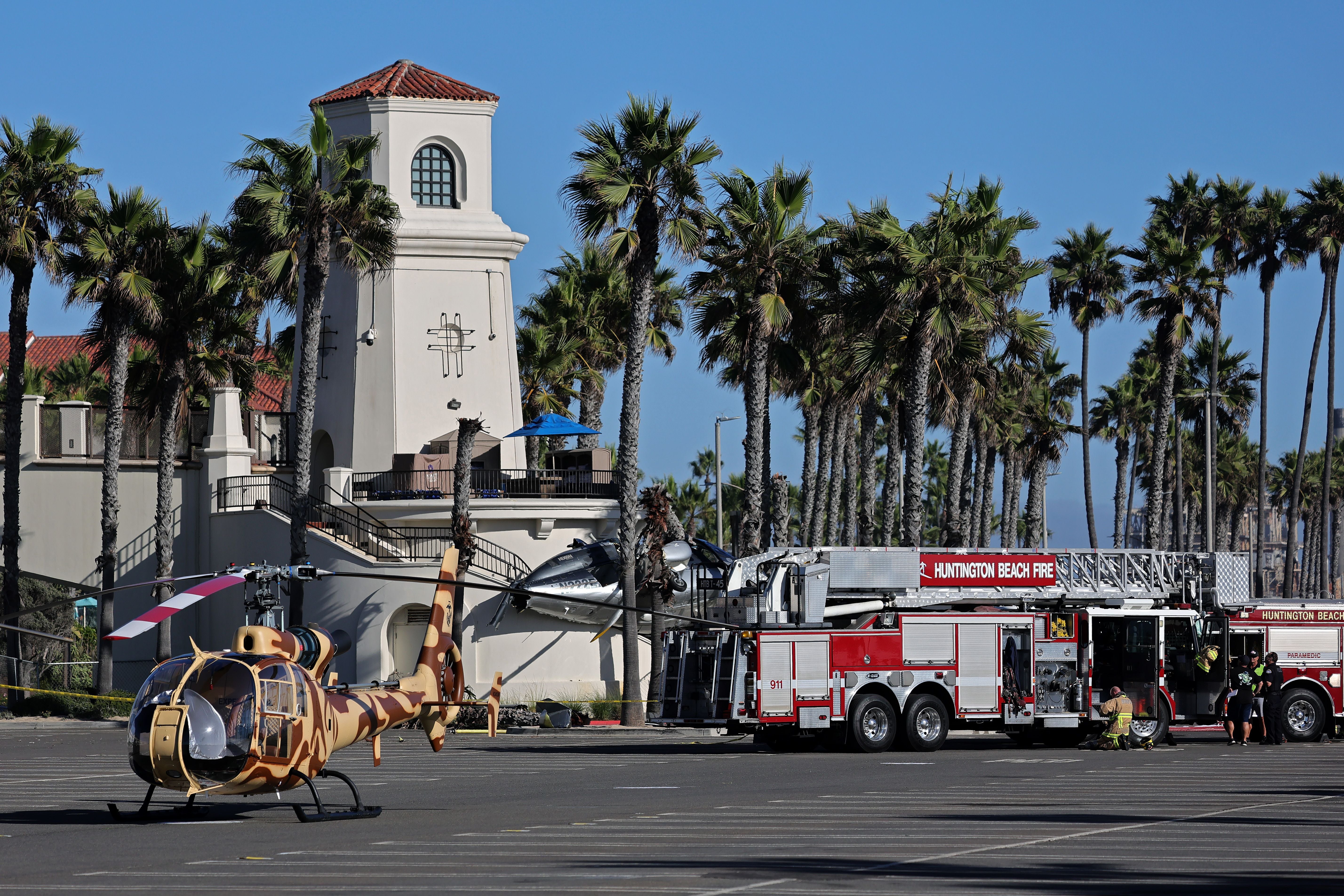 Emergency services attend to a helicopter crash in Huntington Beach