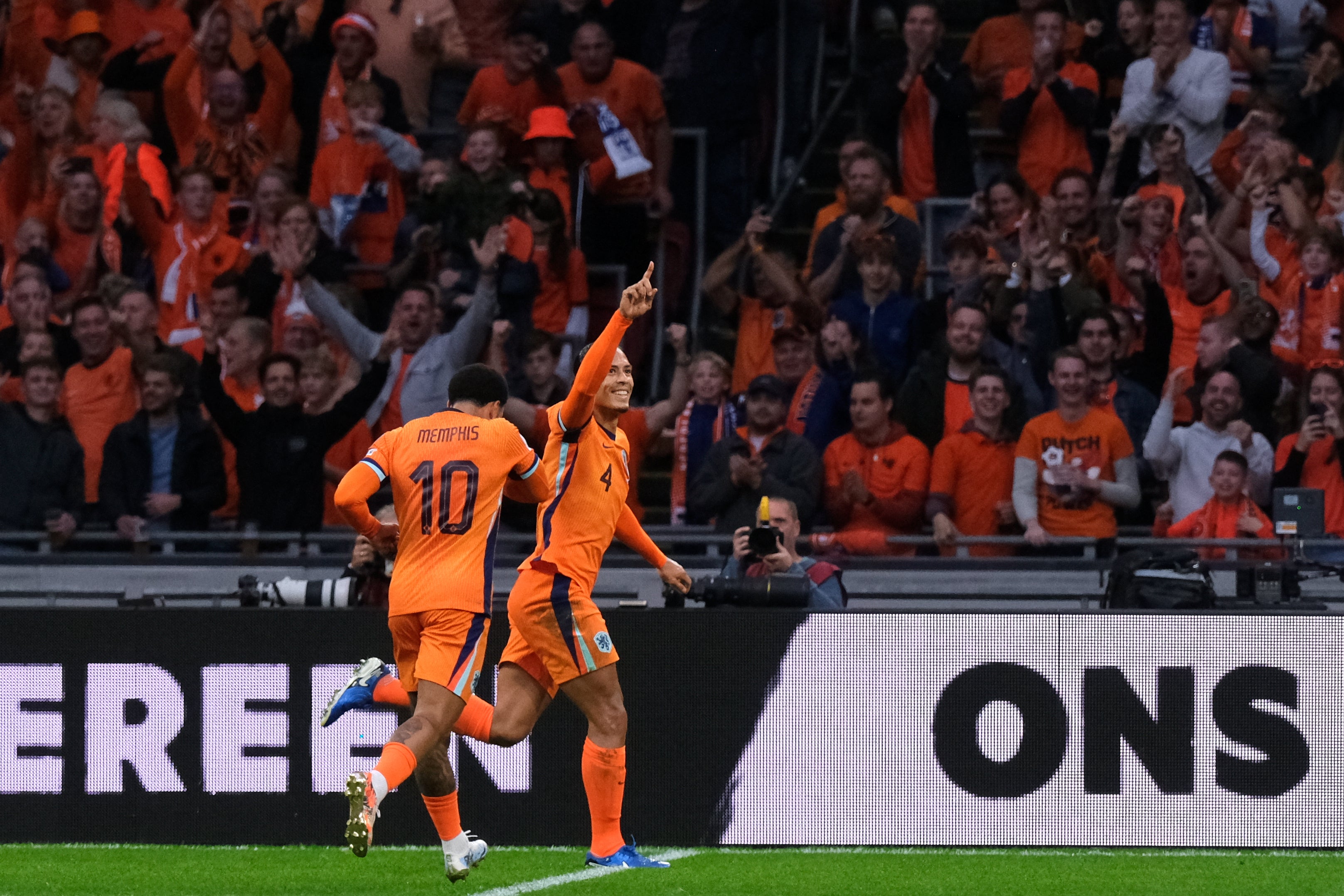 Virgil van Dijk, right, celebrates with Memphis Depay after scoring for the Netherlands (Patrick Post/AP)