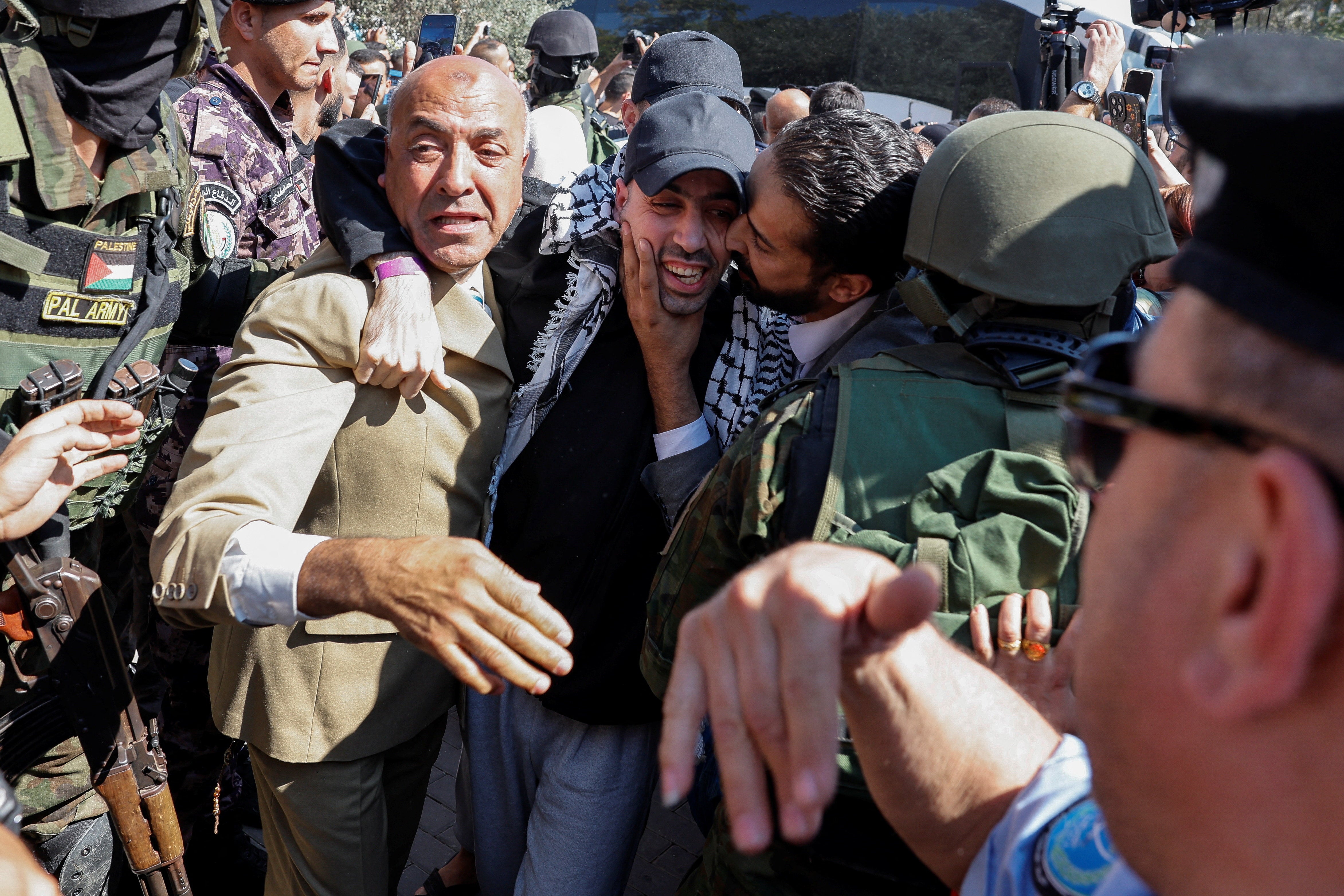 A freed Palestinian prisoner is greeted after he was released from an Israeli jail as part of the ceasefire deal