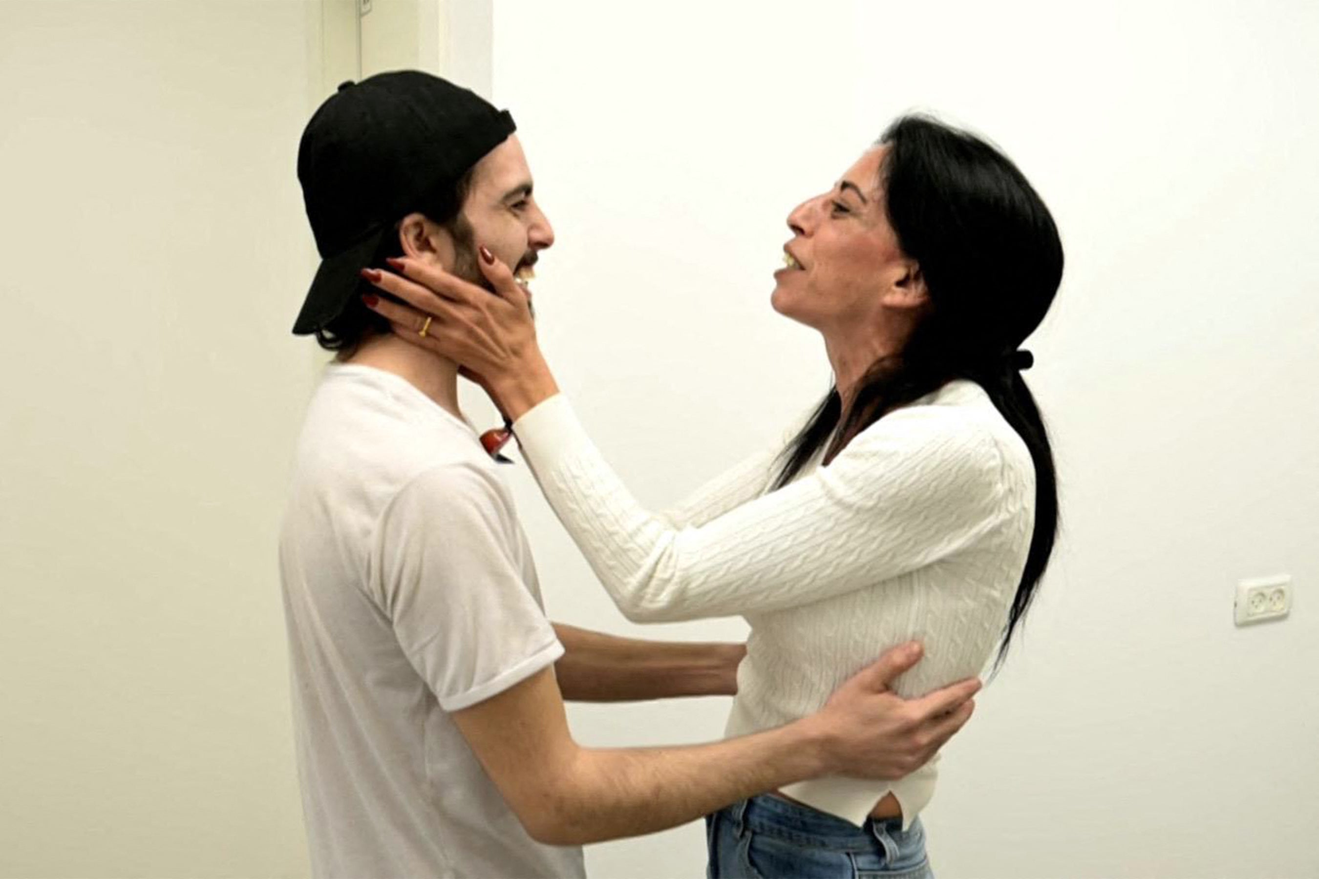 Israeli hostage Matan Zangauker embracing his mother Einav Zangauker after being handed over in a prisoner-hostage swap and a ceasefire deal between Israel and Hamas