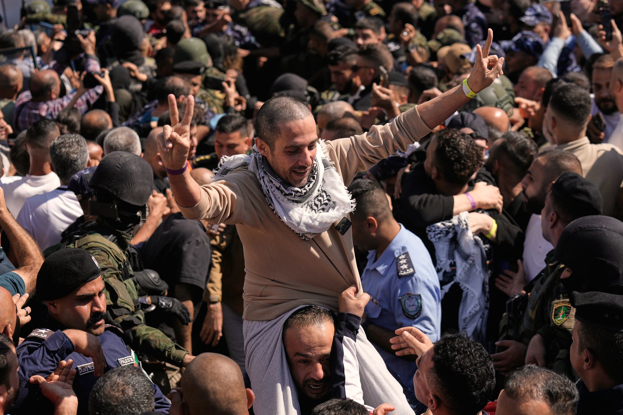 A Palestinian prisoner makes the victory sign after being released from an Israeli prison as part of a ceasefire deal between Israel and Hamas, upon his arrival in the West Bank city of Ramallah, Monday, Oct. 13, 2025. (AP Photo/Majdi Mohammed)