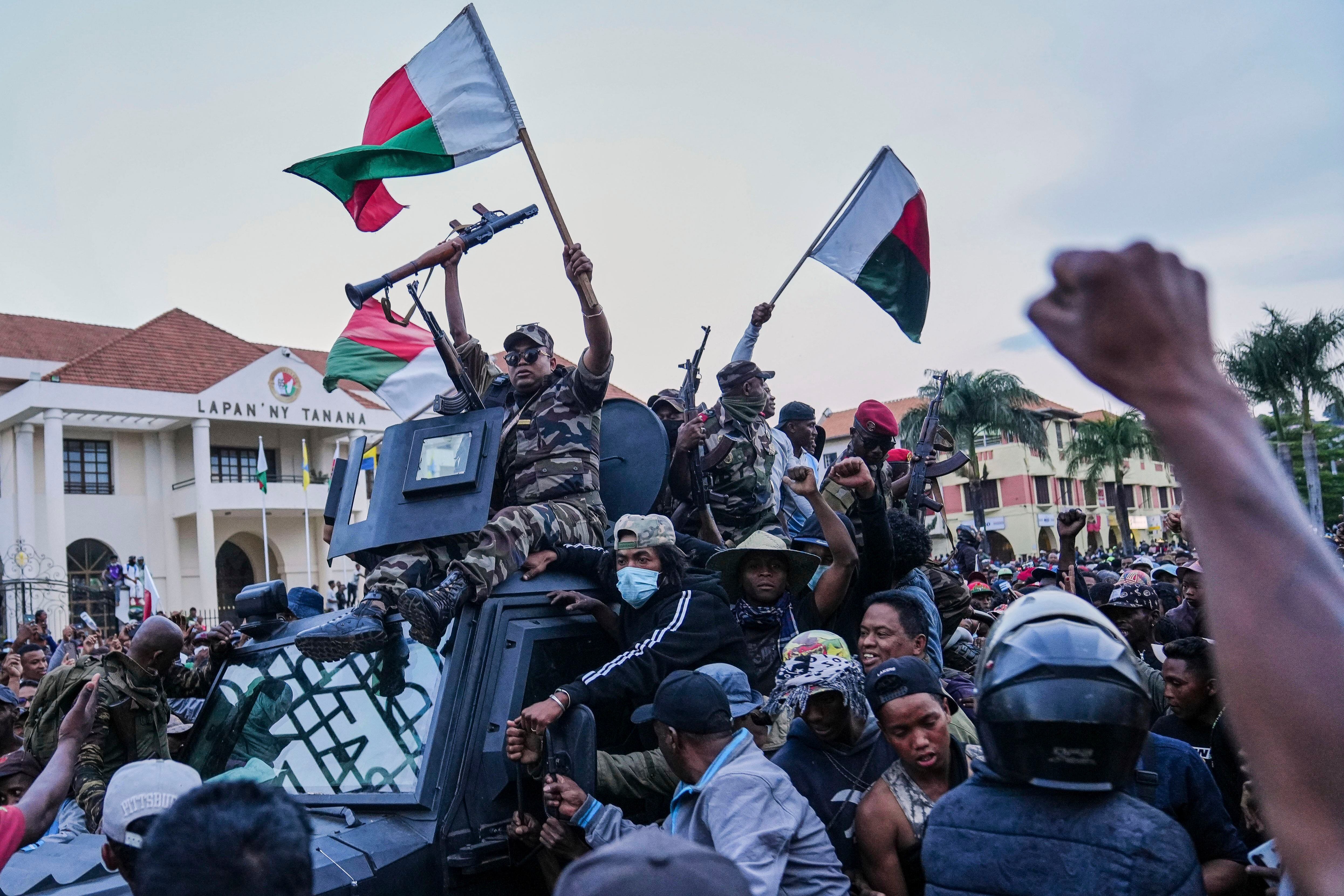 Soldiers are greeted by people at a ceremony to pay tribute to demonstrators killed during recent protests in Antananarivo, Madagascar