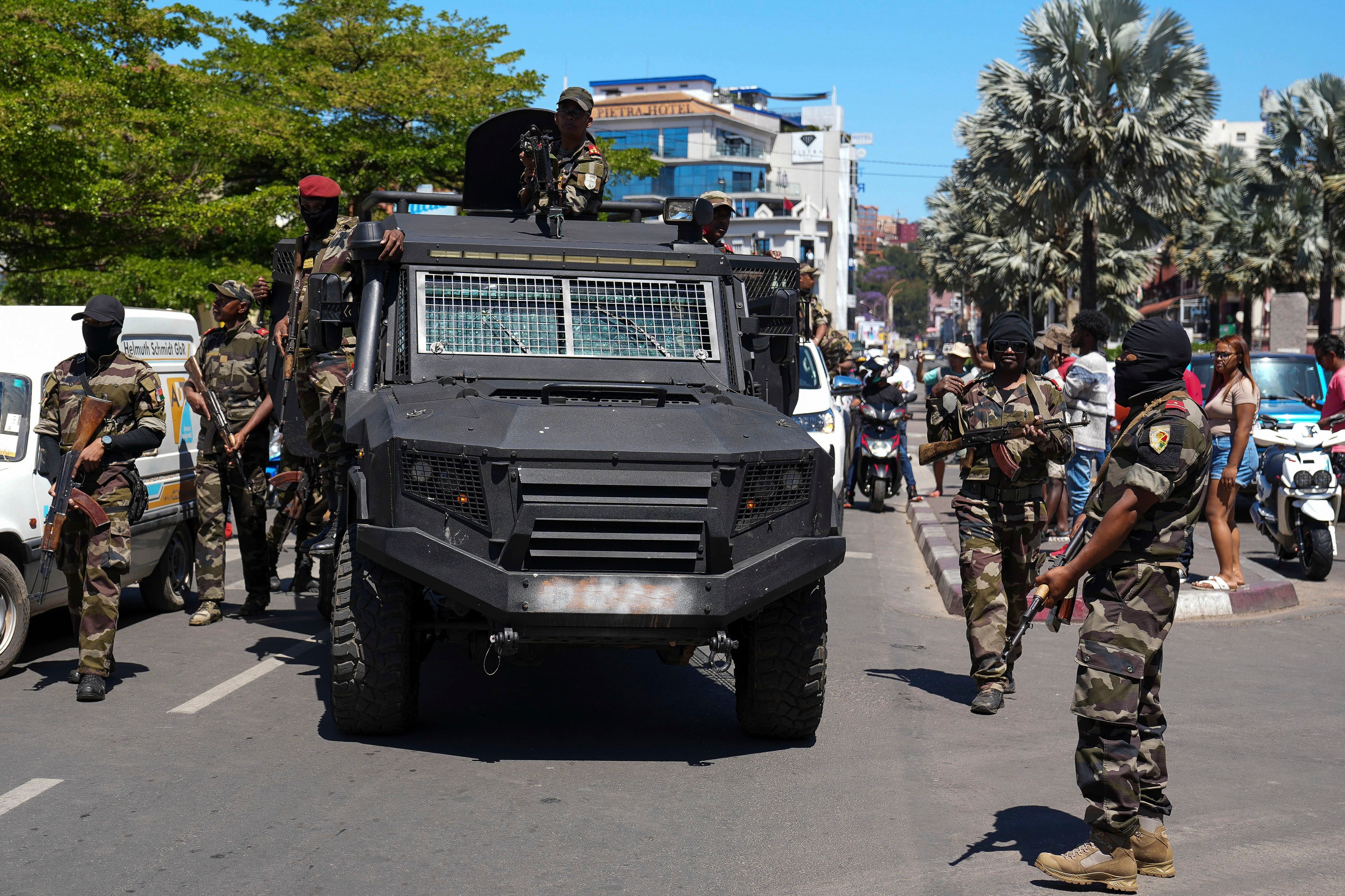 Soldiers are greeted by people at a ceremony to pay tribute to demonstrators killed during recent protests in Antananarivo, Madagascar