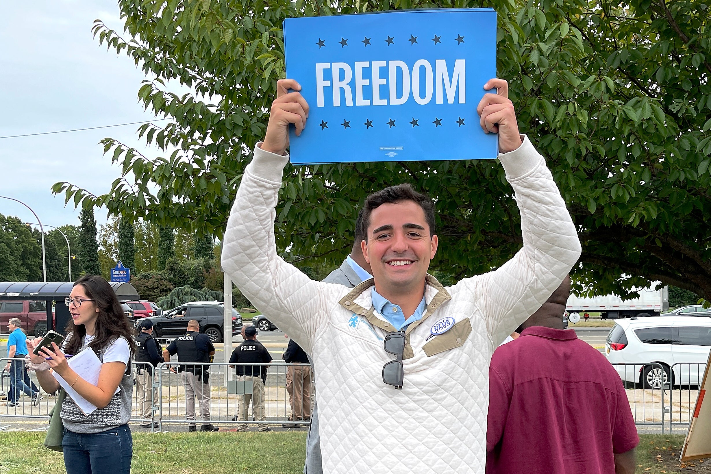 Petros Krommidas holds up a sign during an anti-Trump rally at Nassau Coliseum, in Uniondale, N.Y. (Mark DeFrancesco via AP)