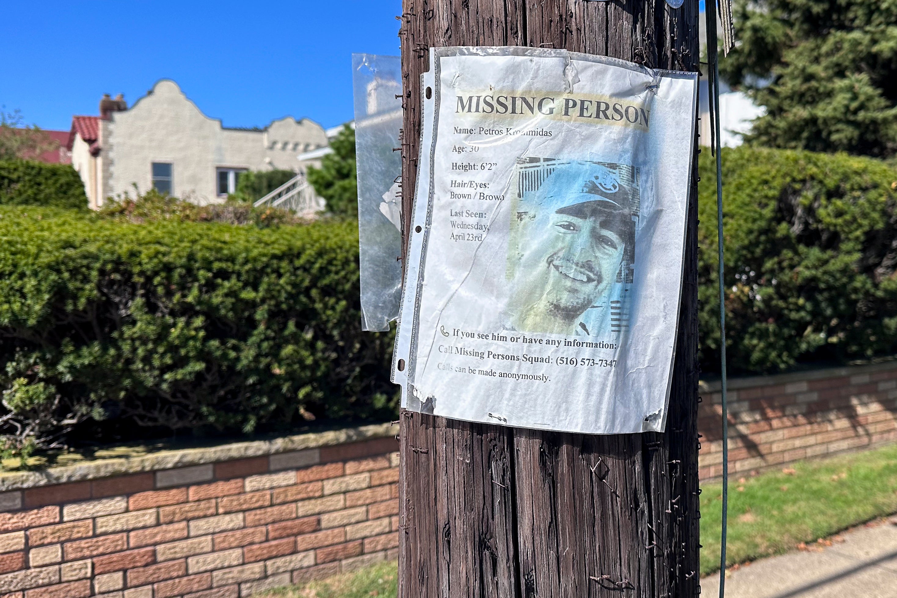 A missing person flyer for Petros Krommidas hangs on a telephone pole in Long Beach (AP Photo/Phillip Marcelo)