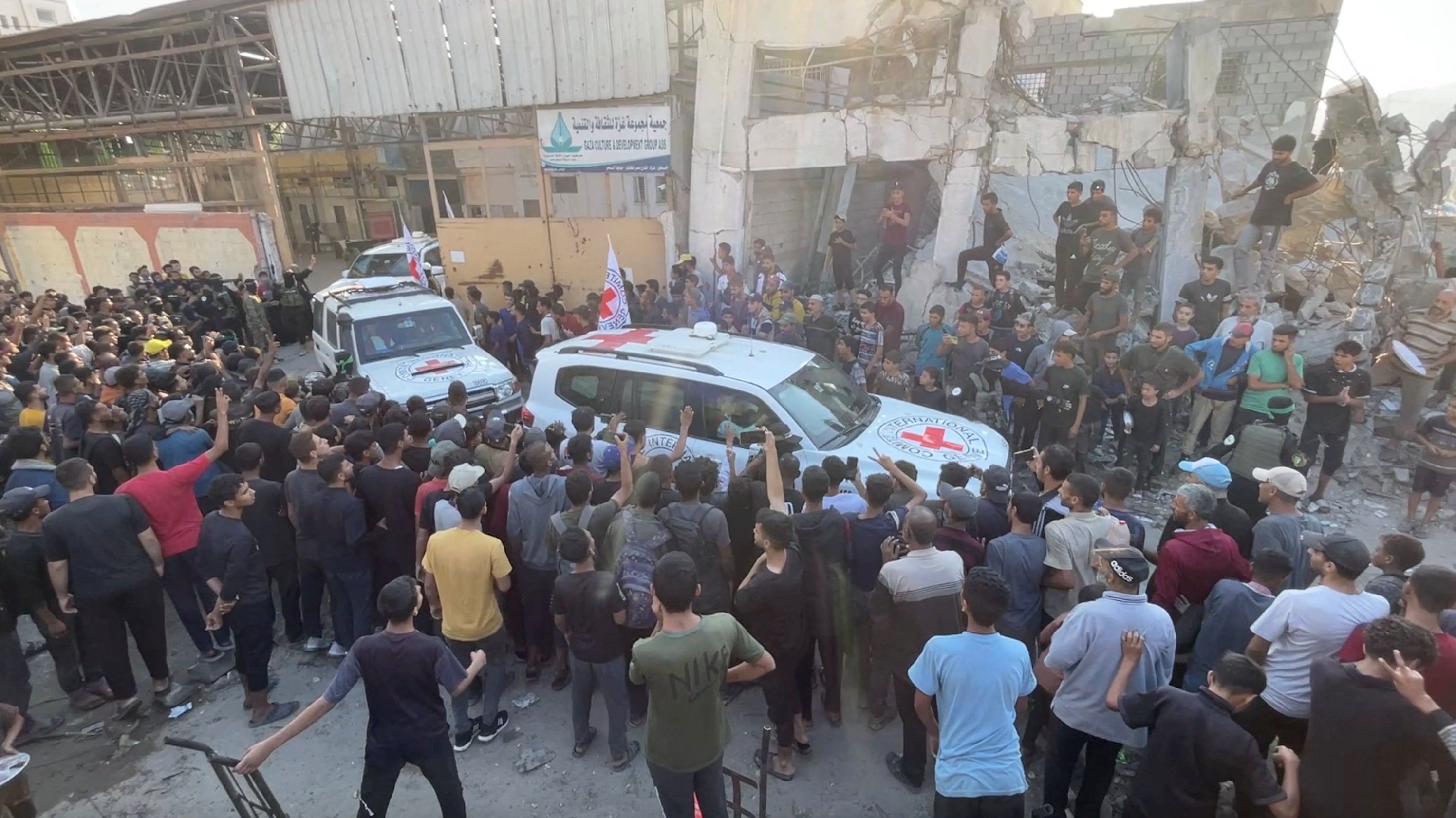 Red Cross vehicles transport Israeli hostages held in Gaza following their handover as part of a ceasefire and hostages-prisoners swap deal between Hamas and Israel