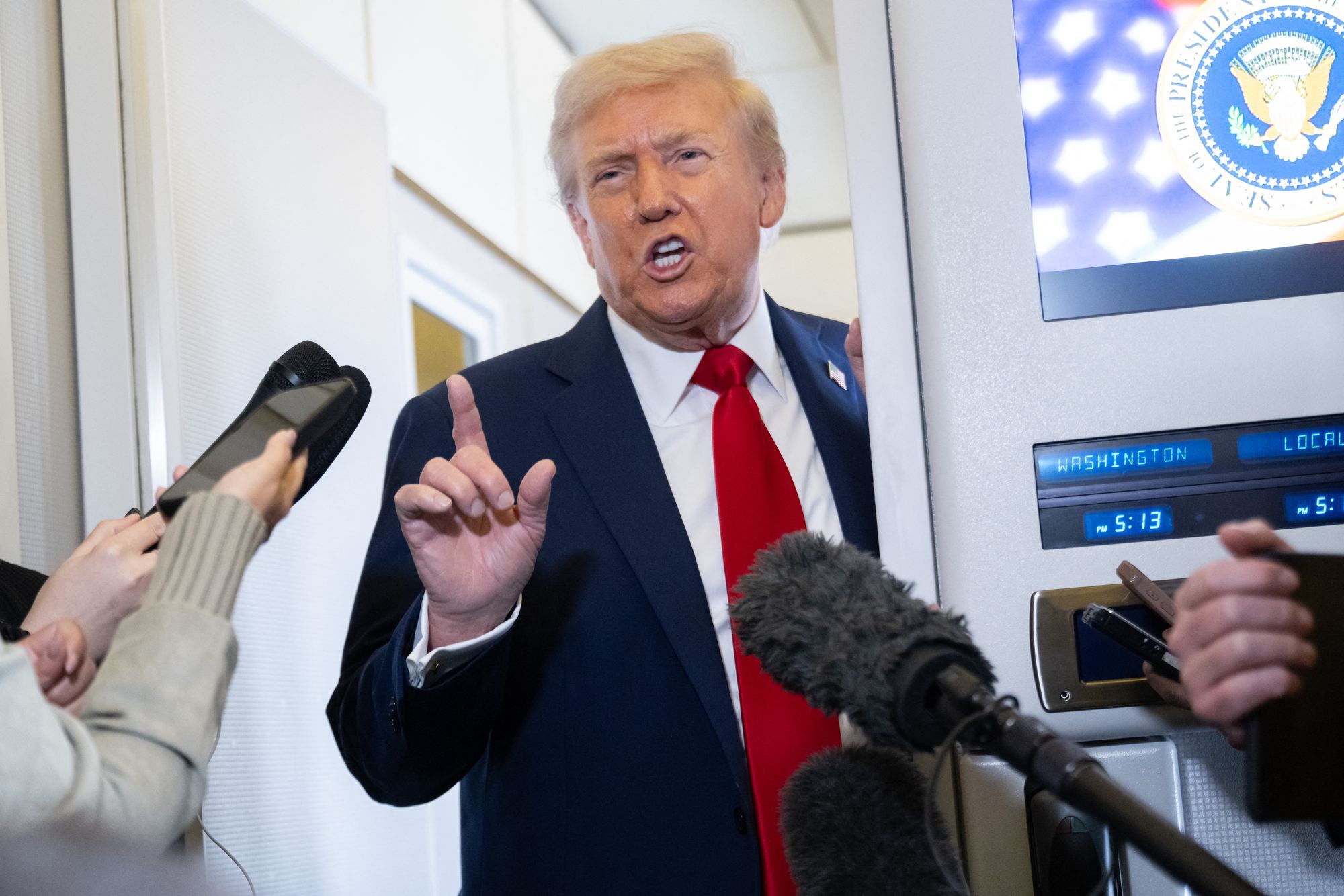 Donald Trump speaks to reporters aboard Air Force One as he flies from Washington DC to Israel