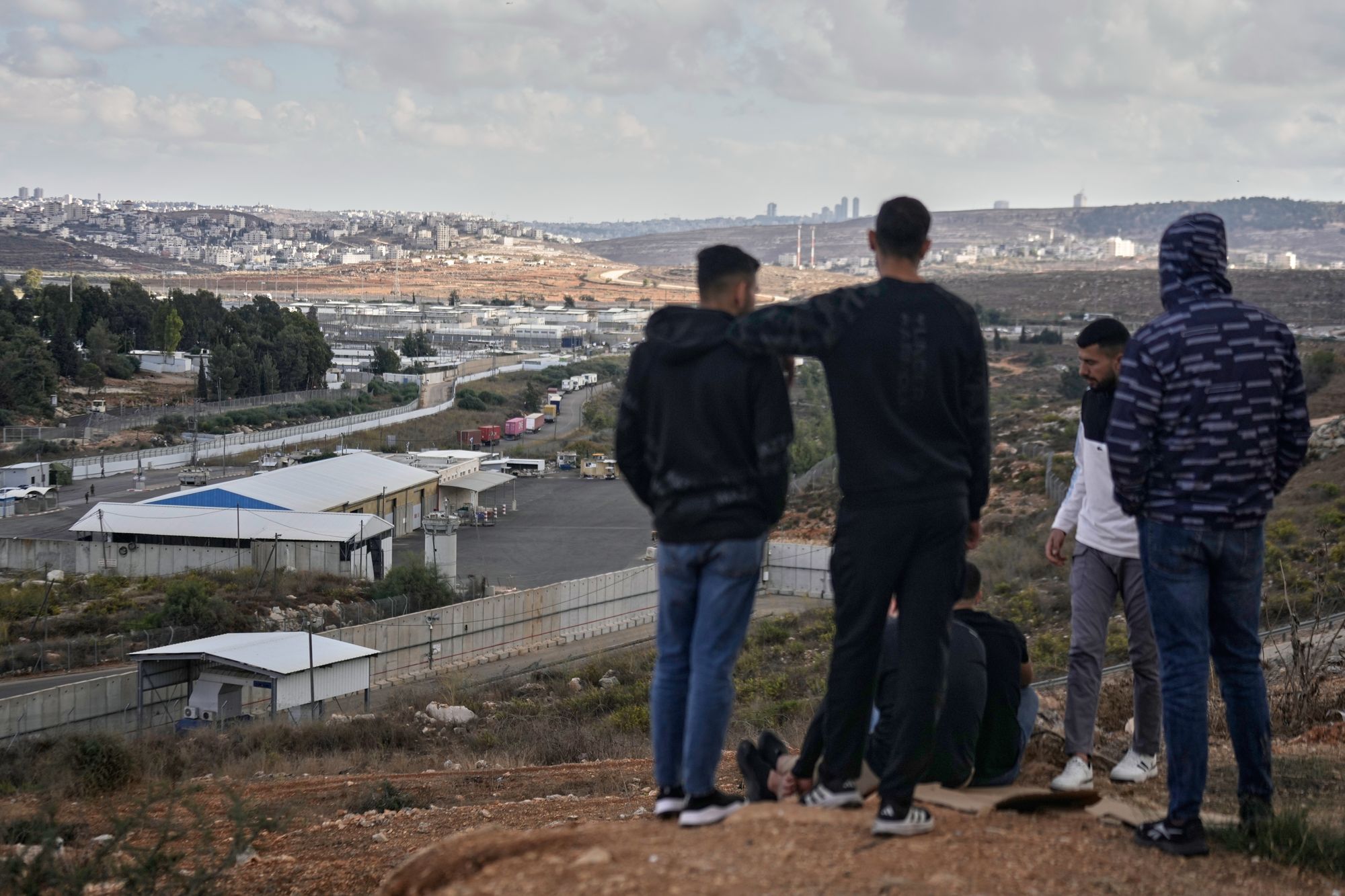Palestinians look at the Israeli Ofer prison in the West Bank city of Beitunia, Monday Oct. 13