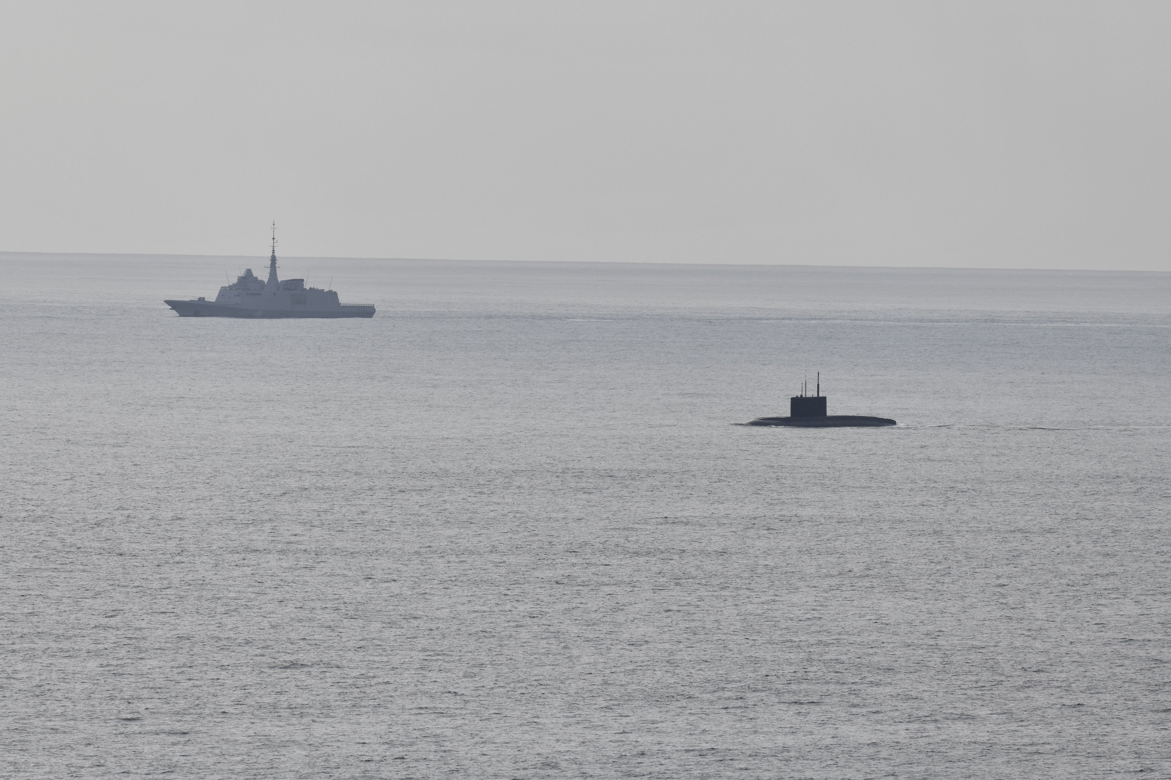 A French navy frigate conducts surveillance of the Alliance’s maritime approaches, marking the presence of a Russian submarine