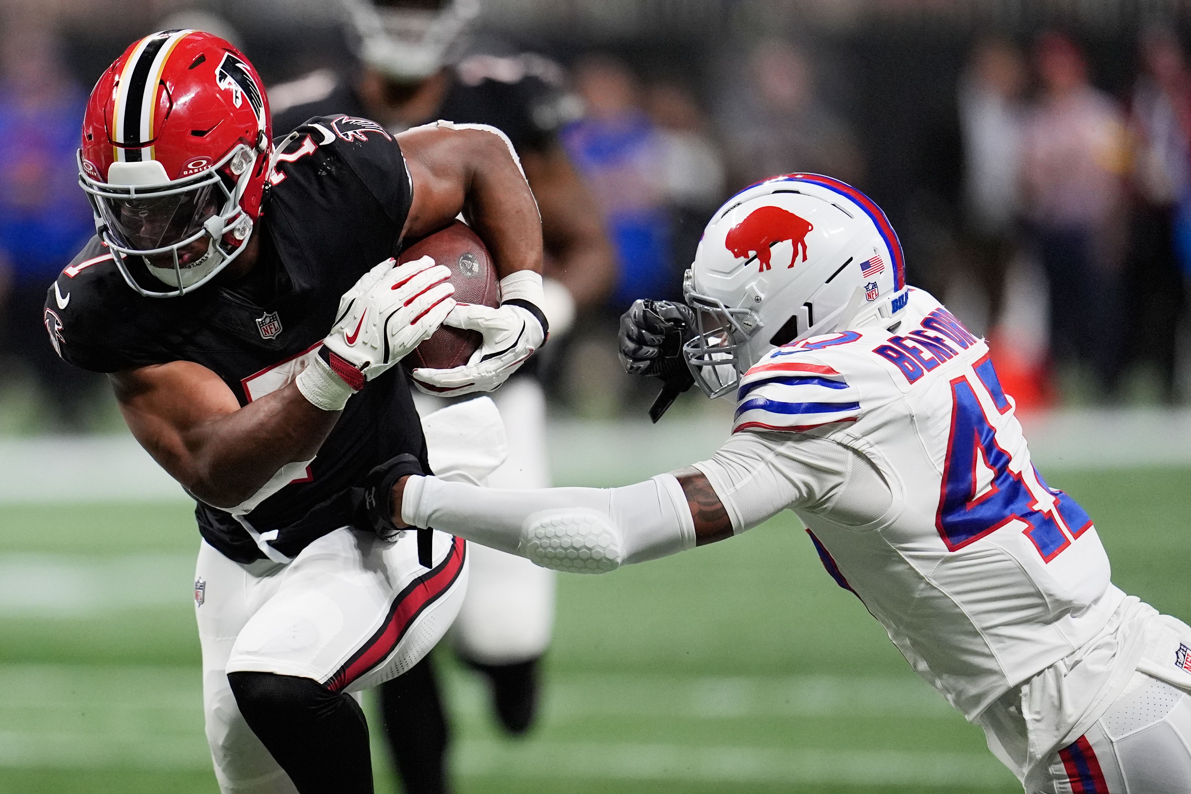 Atlanta Falcons running back Bijan Robinson runs past Buffalo Bills cornerback Christian Benford (Mike Stewart/AP)
