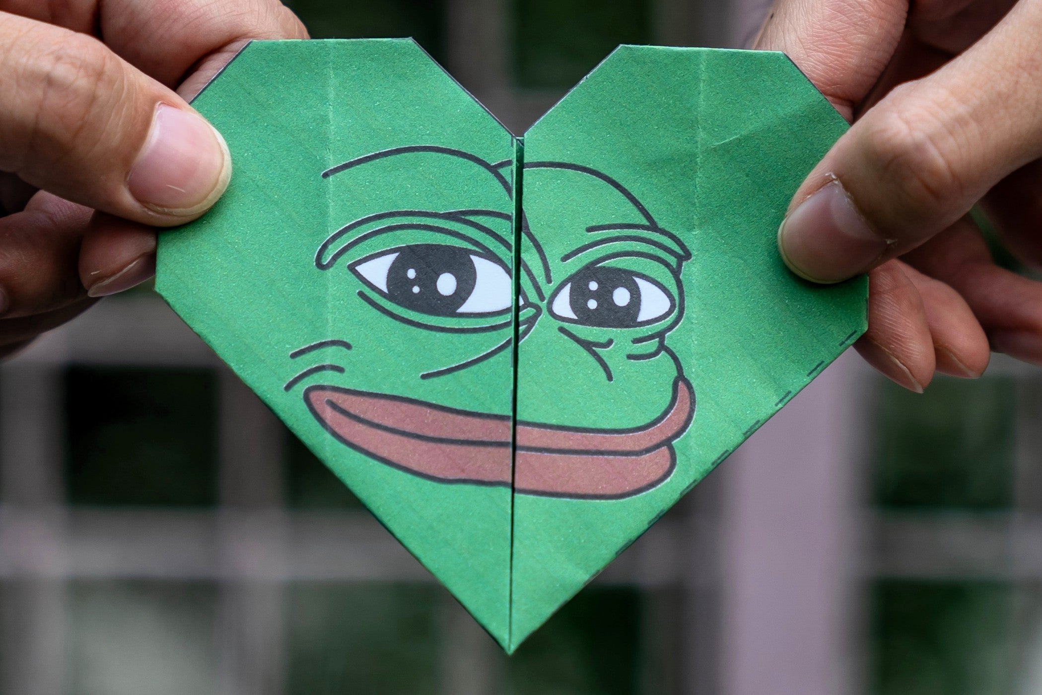 An origami of Pepe the Frog – an online meme that gained popularity through 4chan – is held up during protests in Hong Kong on 24 September, 2019