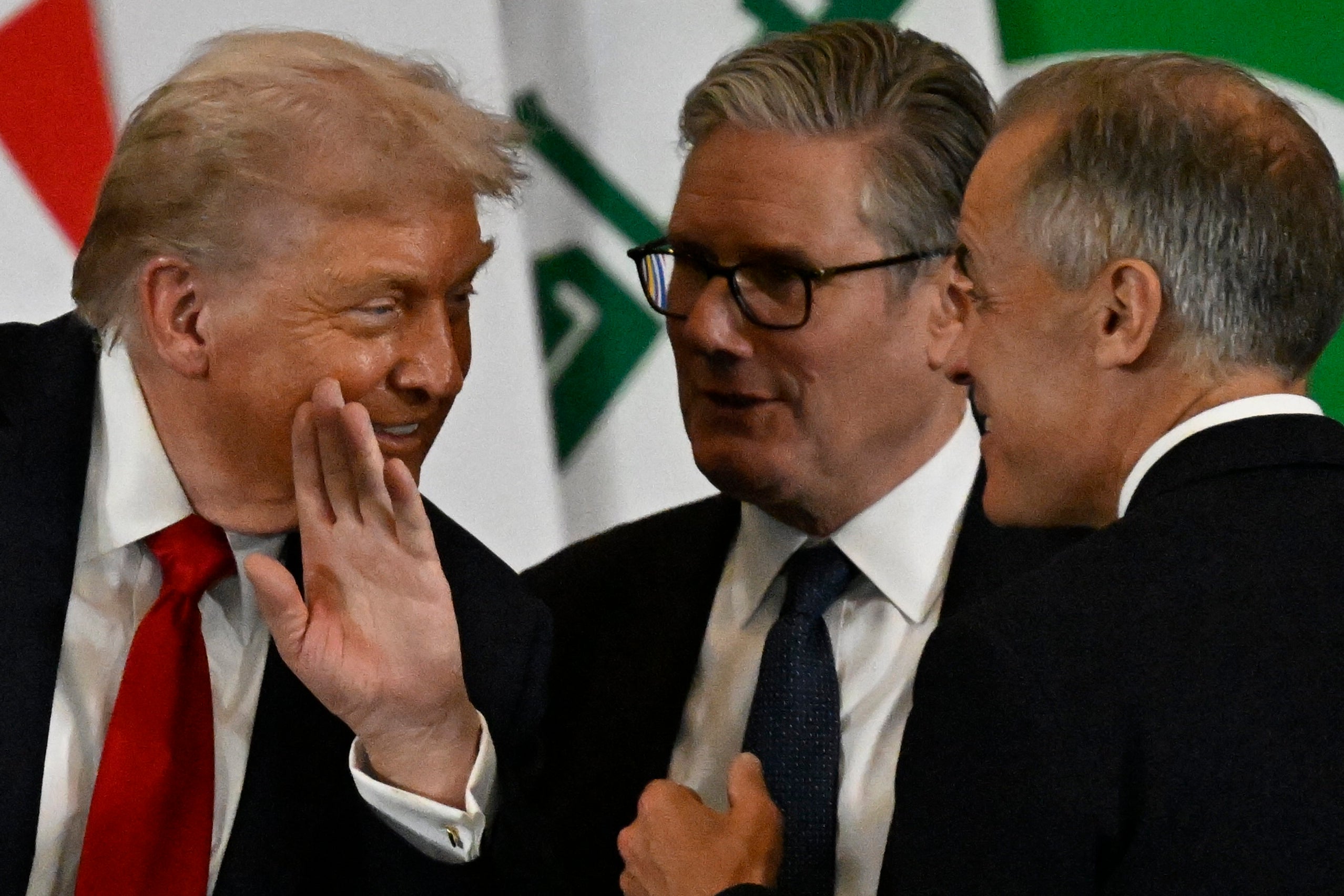 President Donald Trump whispers to Canadian Prime Minister Mark Carney and British PM Keir Starmer during the Israel-Hamas peace summit in Egypt