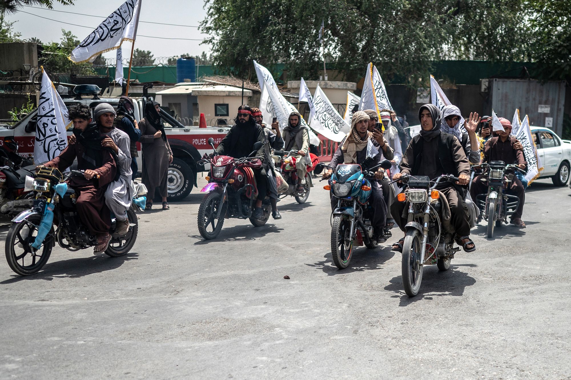 A convoy of Taliban security personnel moves along a Kabul street as they celebrate the fourth anniversary of their takeover of Afghanistan this summer