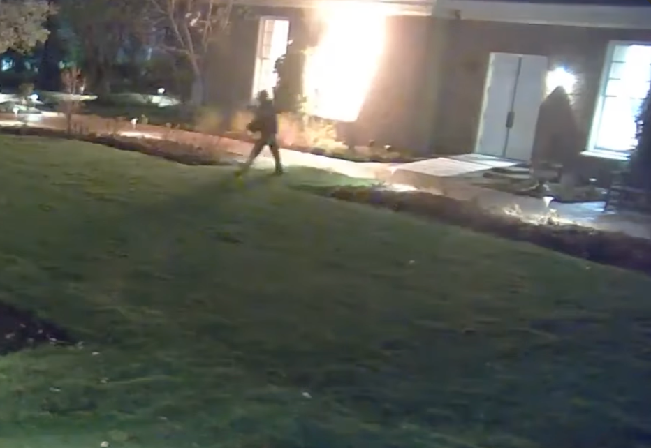 Balmer walking away from Shapiro's home after setting it on fire.