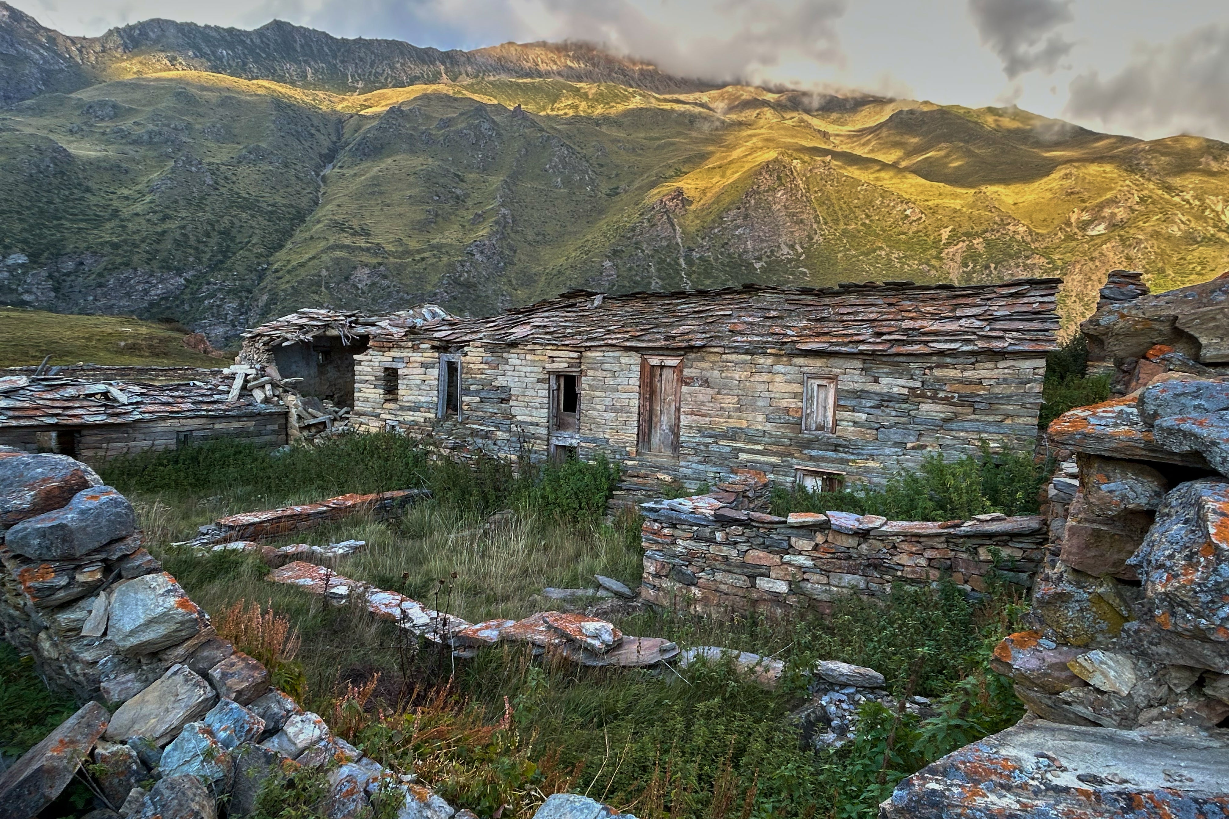 Lichen grows on walls of abandoned stone houses in Martoli village, in the northern Indian Himalayan state of Uttarakhand