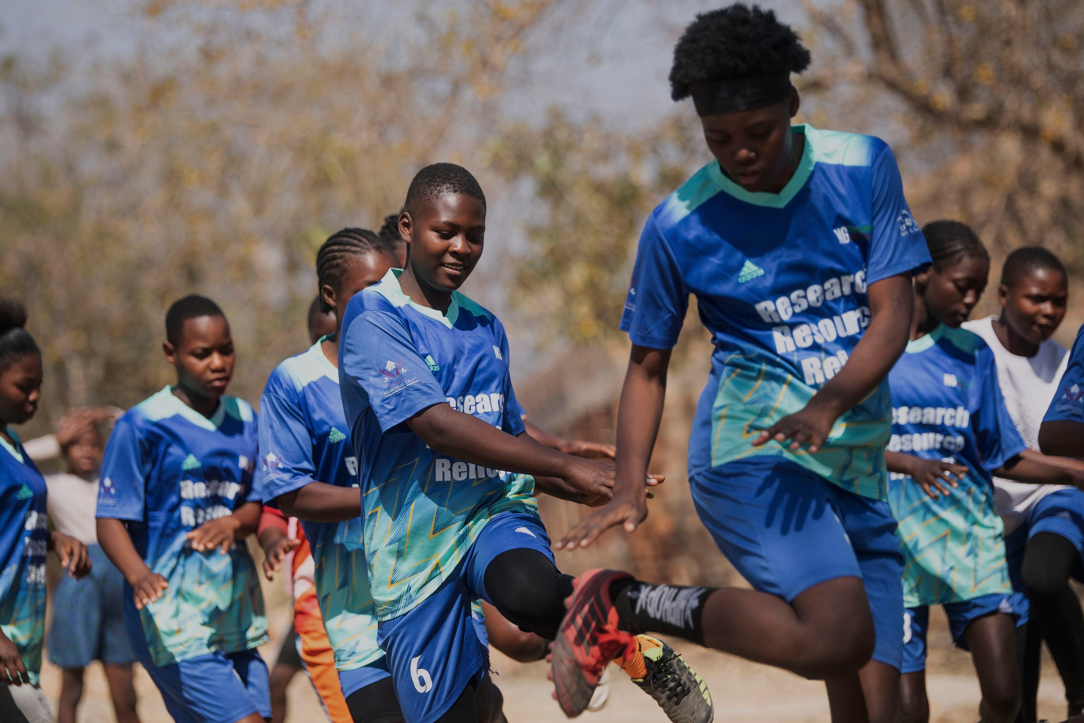 Girls warm up for a soccer match as part of activities against early child marriages and teen pregnancies at a school in Shamva, Zimbabwe, Friday, Aug. 29, 2025. (AP Photo/Aaron Ufumeli)