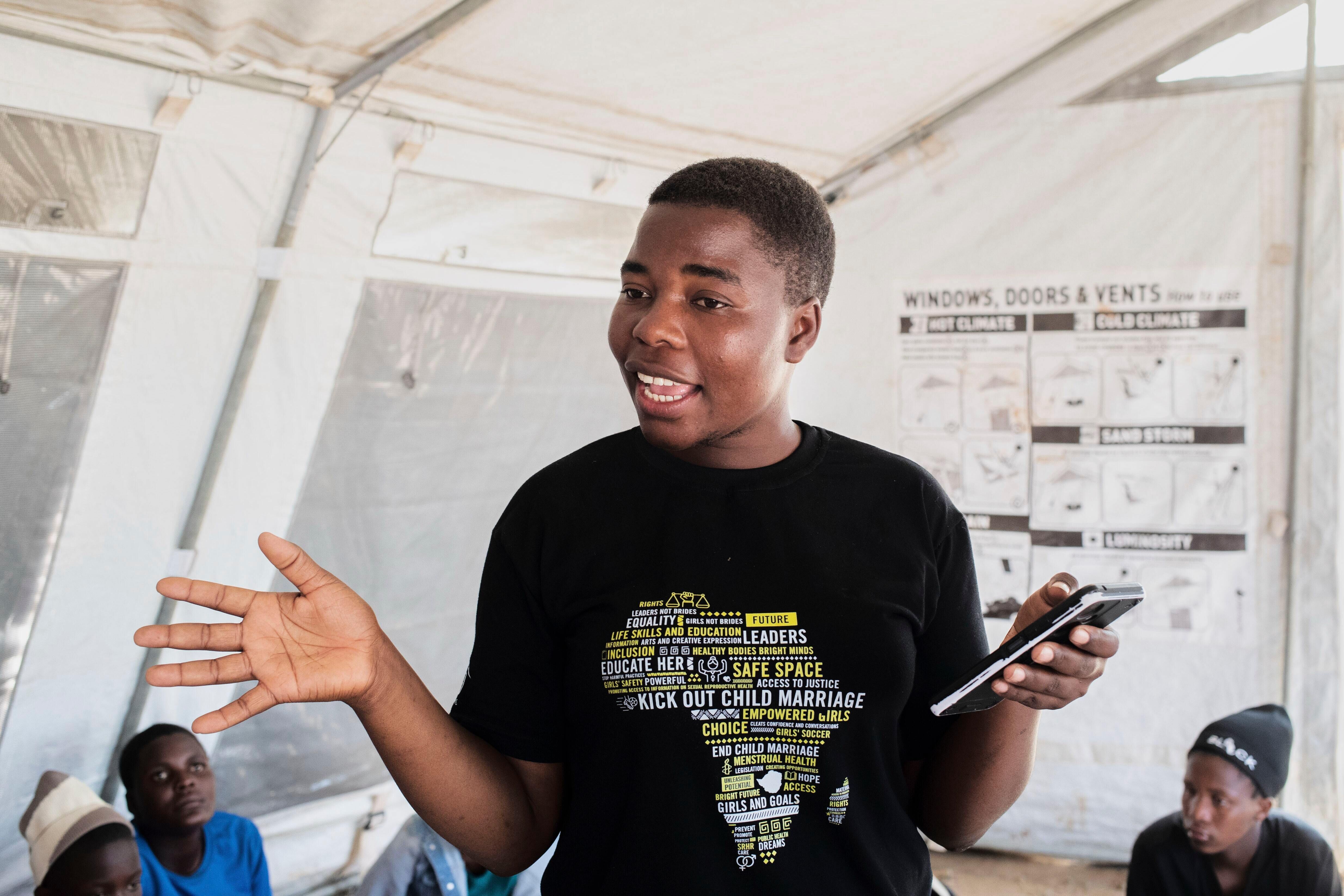 Samantha Chidodo speaks as she gives advice to girls and women about early child marriages and teen pregnancies in Shamva, Zimbabwe, Friday, Aug. 29, 2025. (AP Photo/Aaron Ufumeli)