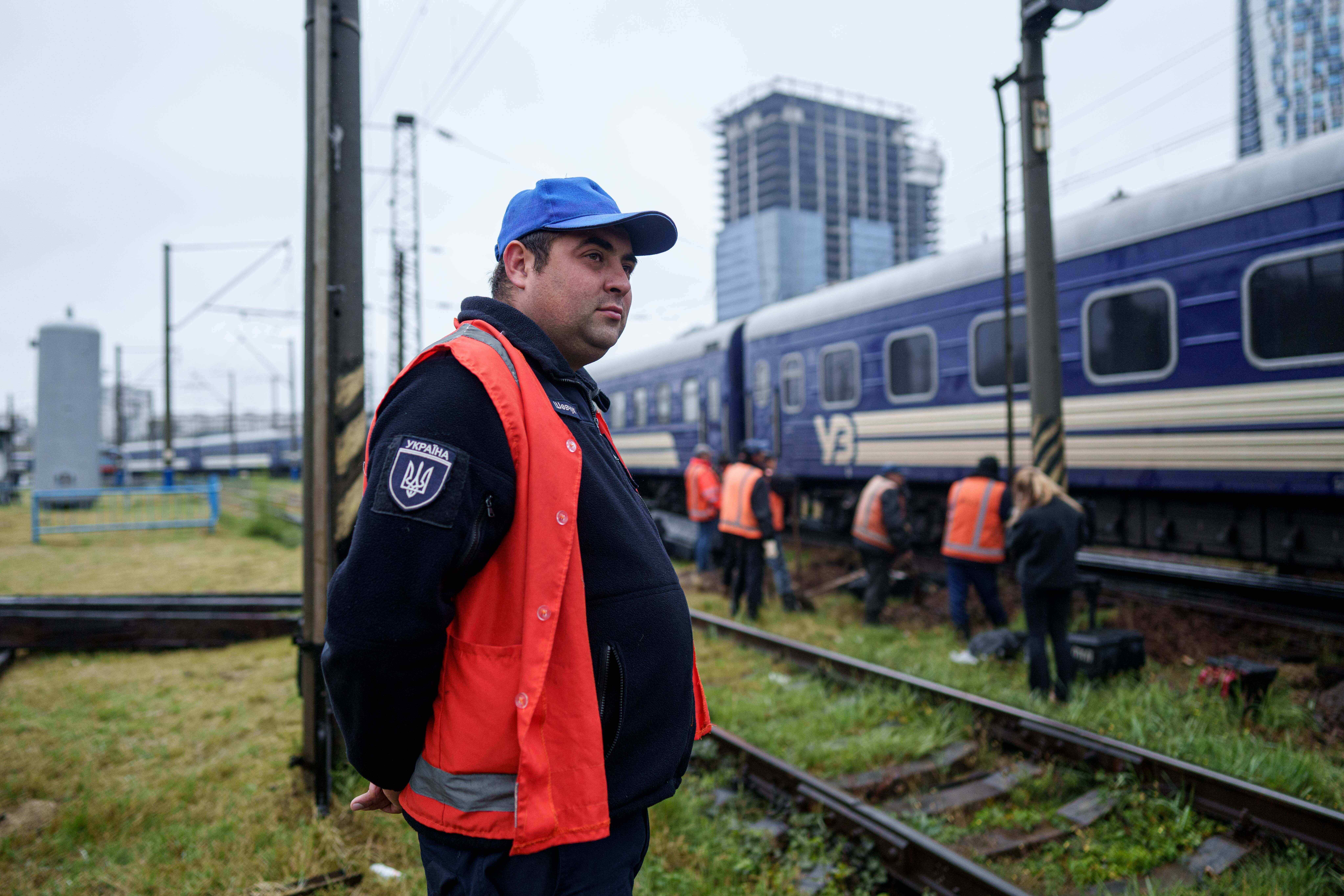 Shevcuk Maksym, 30, a railway repair team leader, looks at railway track repair work in Kyiv, Ukraine, Thursday, Oct. 2, 2025. (AP Photo/Evgeniy Maloletka)