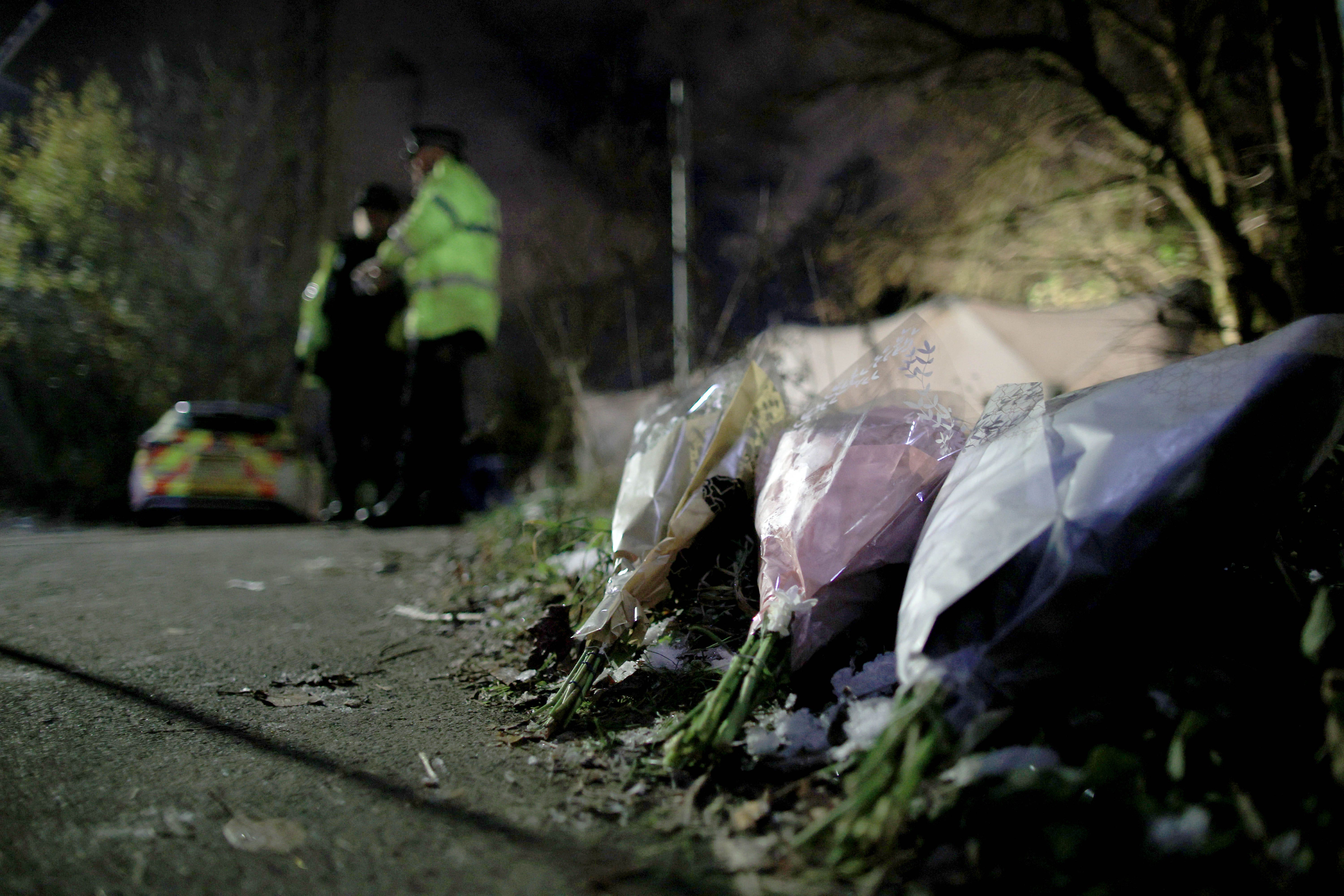 Flowers left at the scene on Ravenscraig Road near Ashtons Field, Salford, in Greater Manchester, where the remains of a baby were found in a field (Ryan Jenkinson/PA)