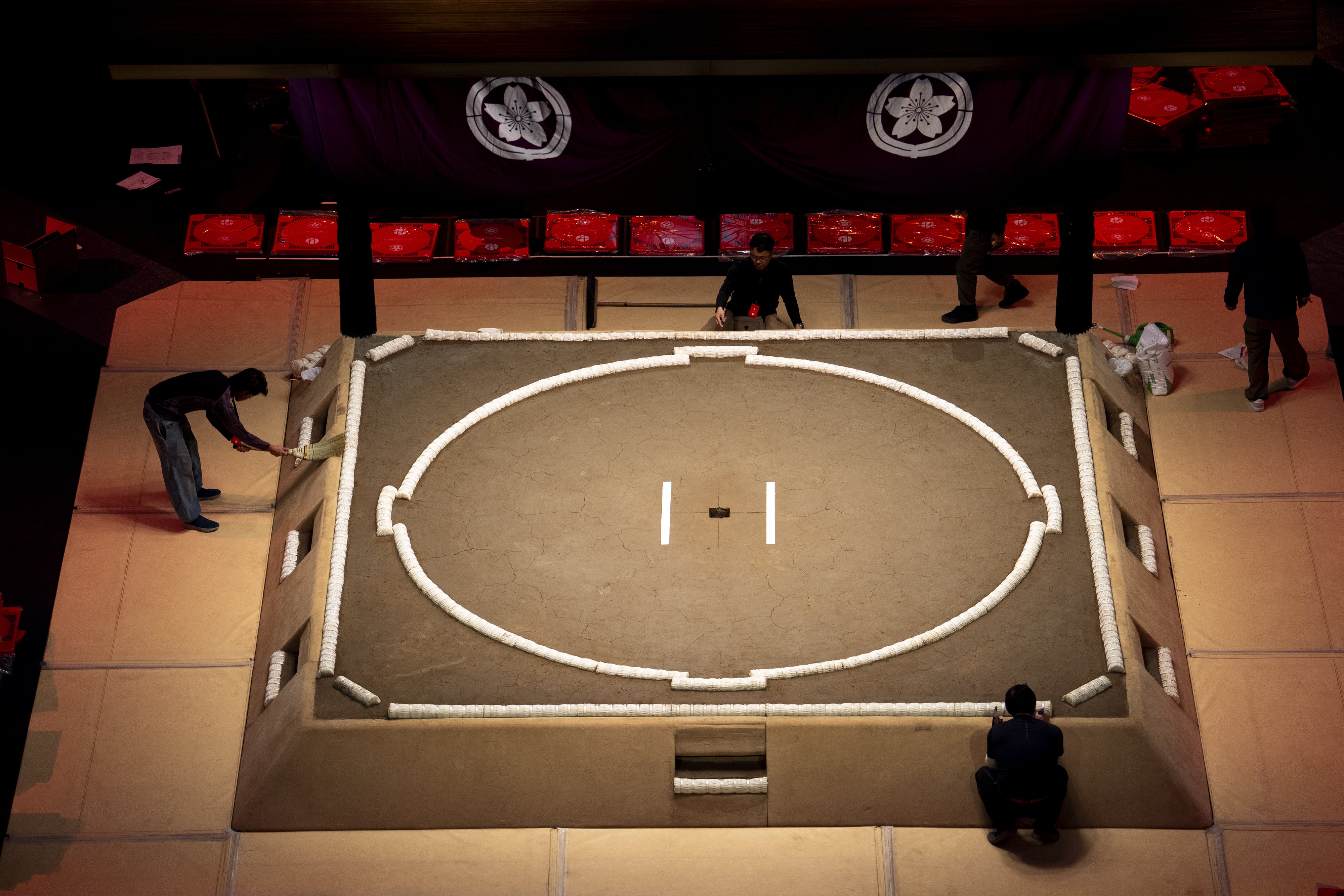 The final touches are applied to the dohyo ahead of the Grand Sumo Tournament