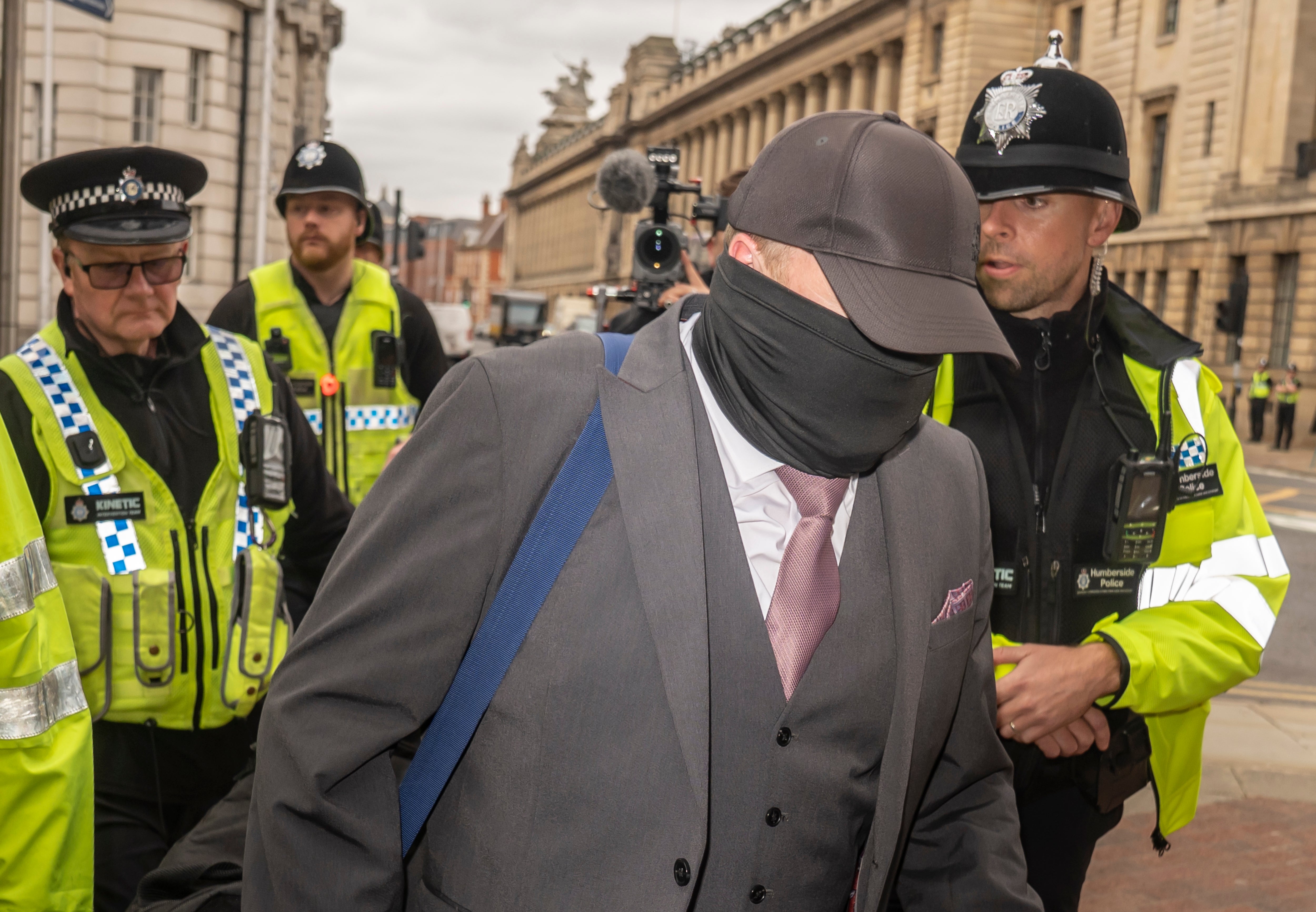 Bush was flanked by officers as he arrived at Hull Crown Court