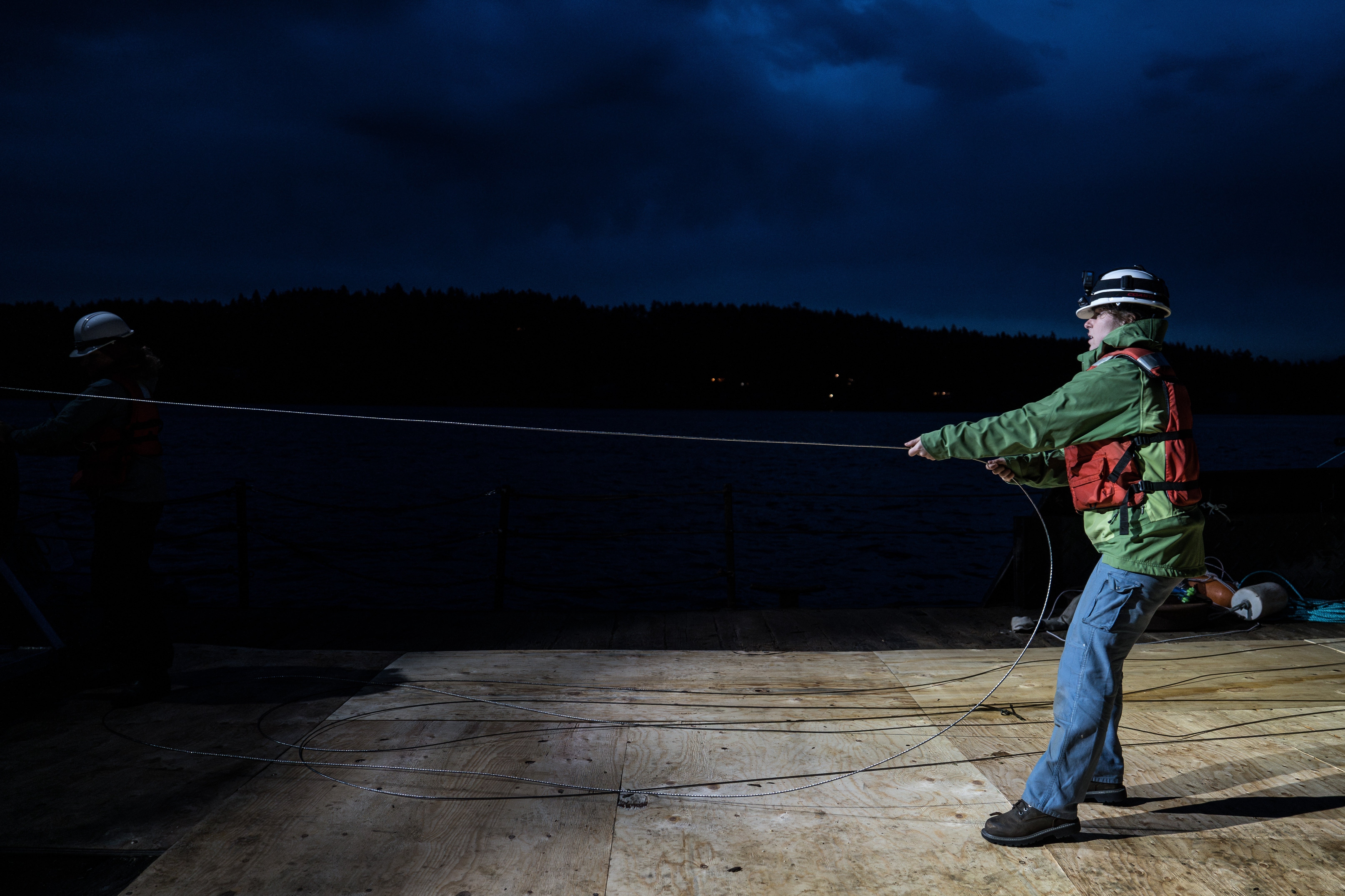 Isabelle Brandicourt, a graduate student at the University of Washington School of Oceanography, prepares to deploy a 1.3-mile fiber-optic cable to test whether internet cables can detect endangered orca vocalizations near San Juan Island, Wash.