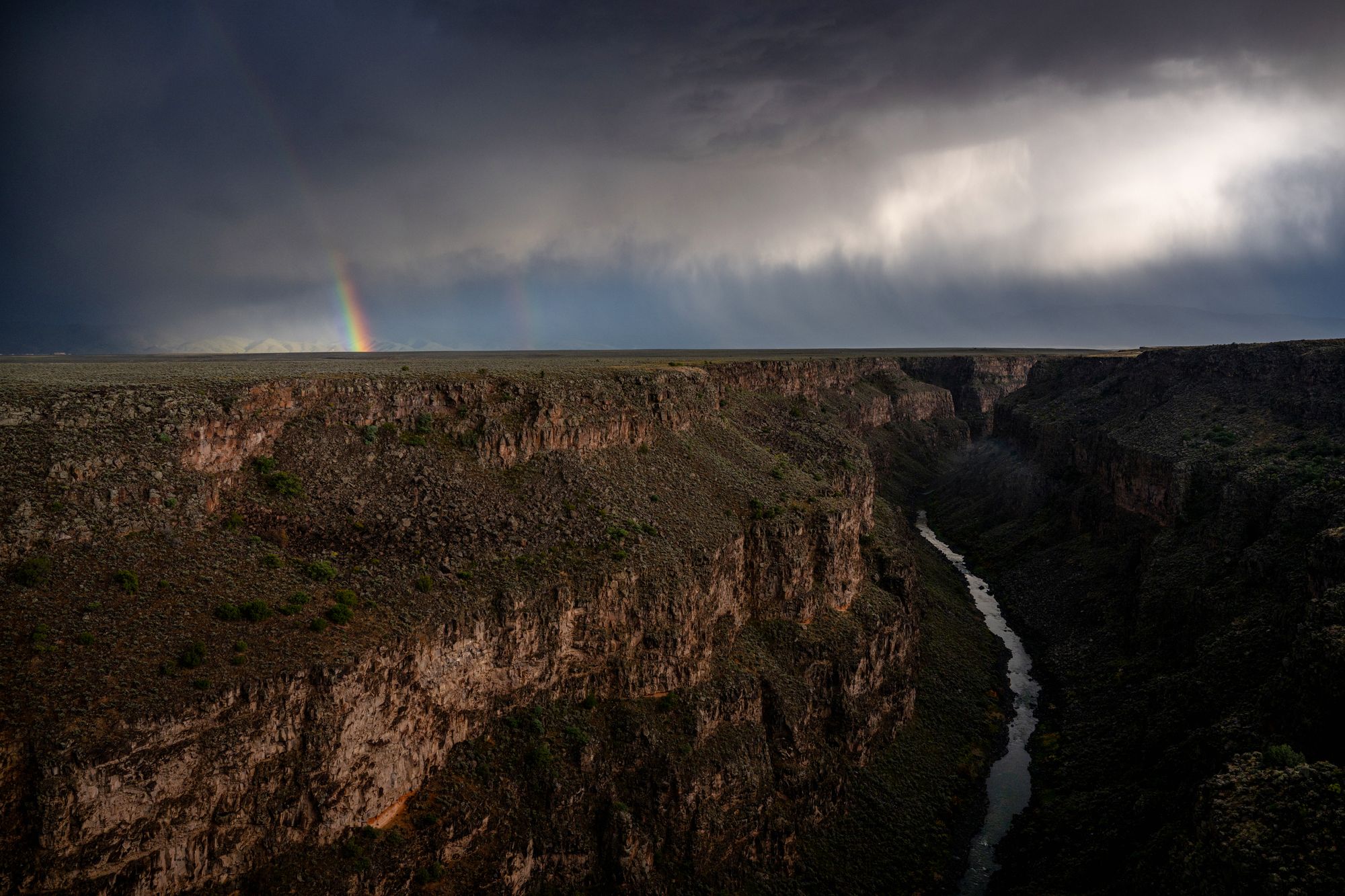 New Mexico authorities were forced to rescue an irate man who got stuck after climbing down the ledge of a gorge while trying to reach a nearby hot springs