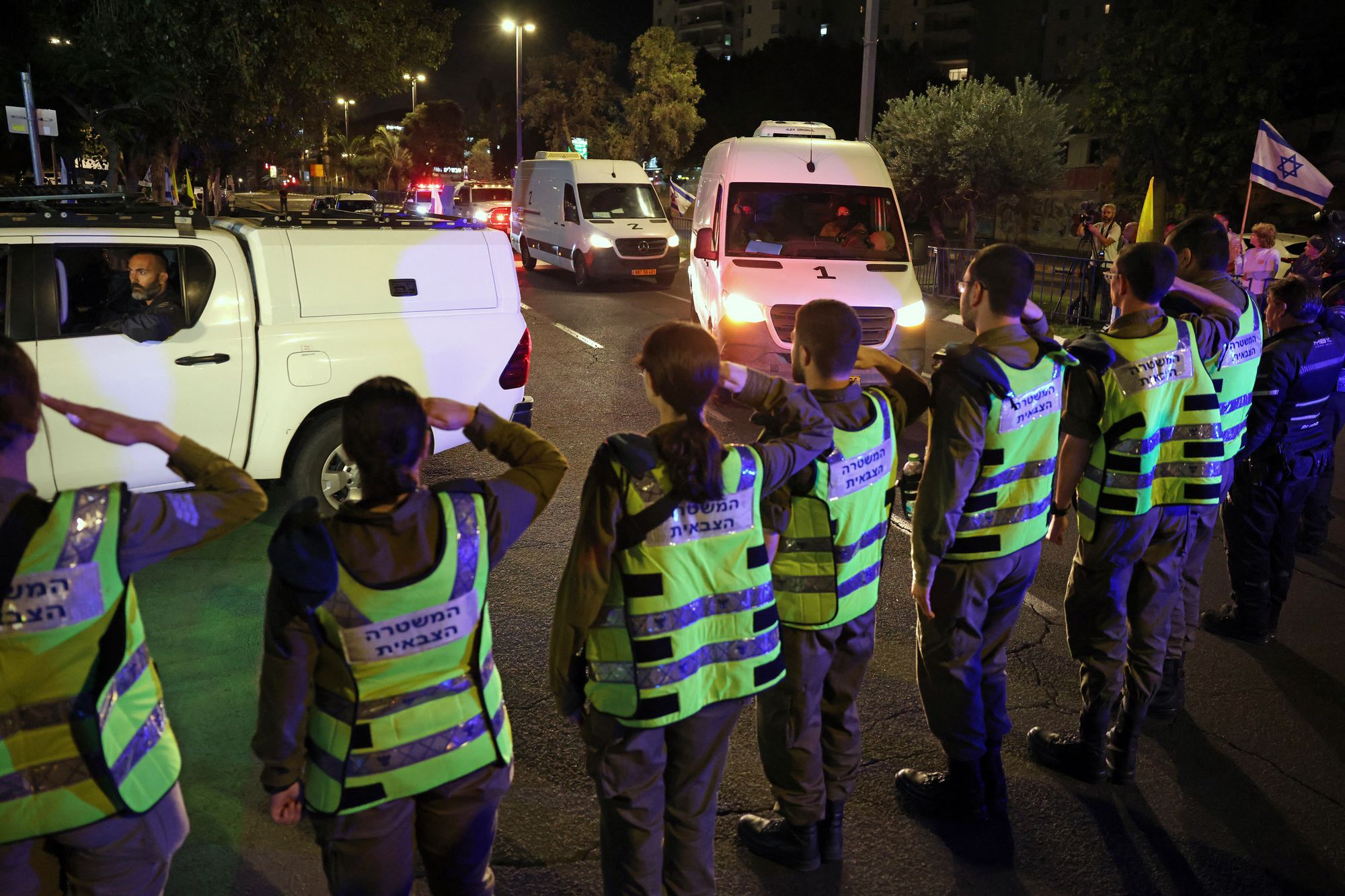 Vehicles carrying four bodies arrive at the National Centre for Forensic Medicine, in Tel Aviv, on 15 October