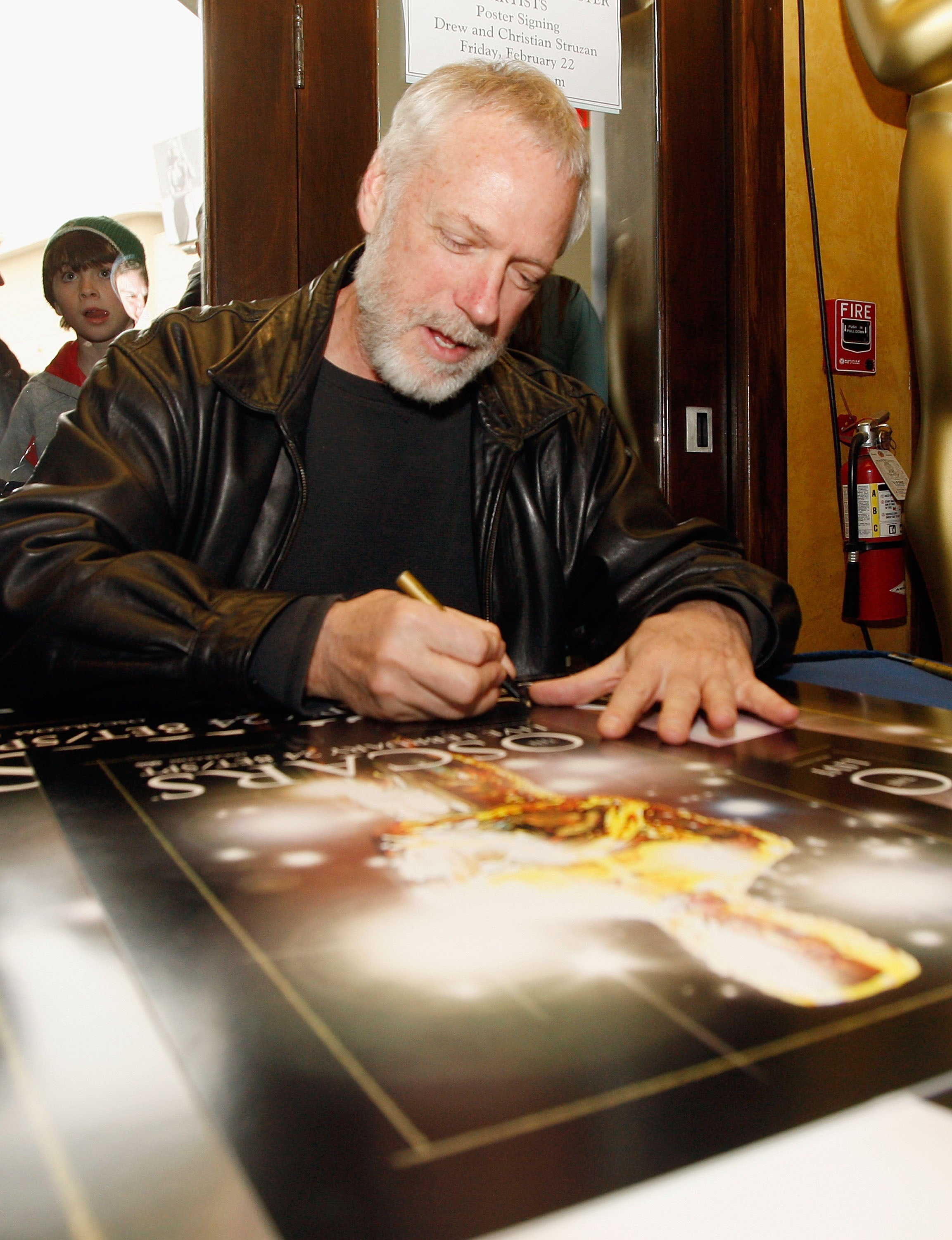 Drew Struzan signs copies of the Oscar poster at the Hollywood and Highland Centre