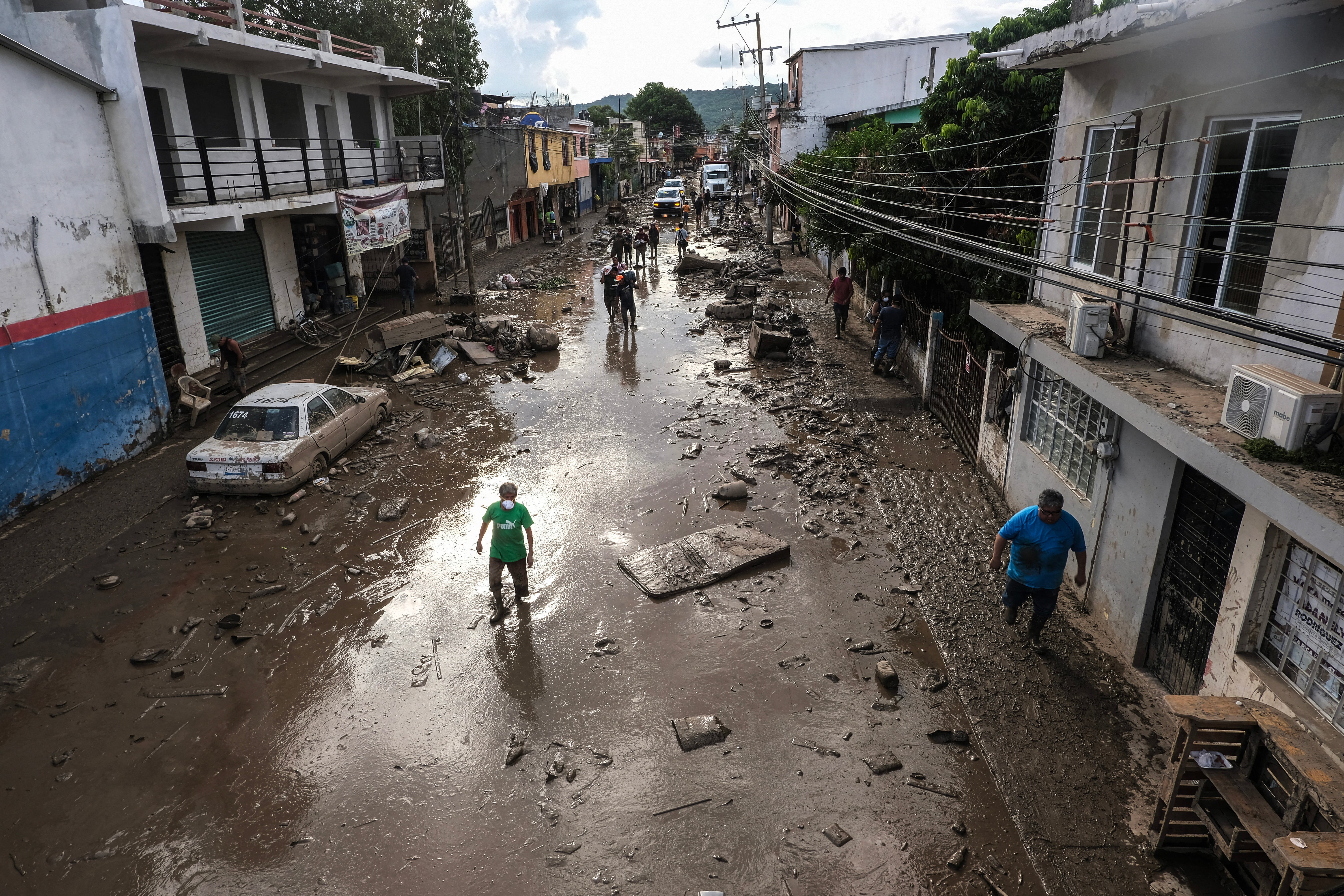 Street covered in mud and debris caused by heavy rains in the Las Granjas neighborhood in Poza Rica, Veracruz state, on 14 October