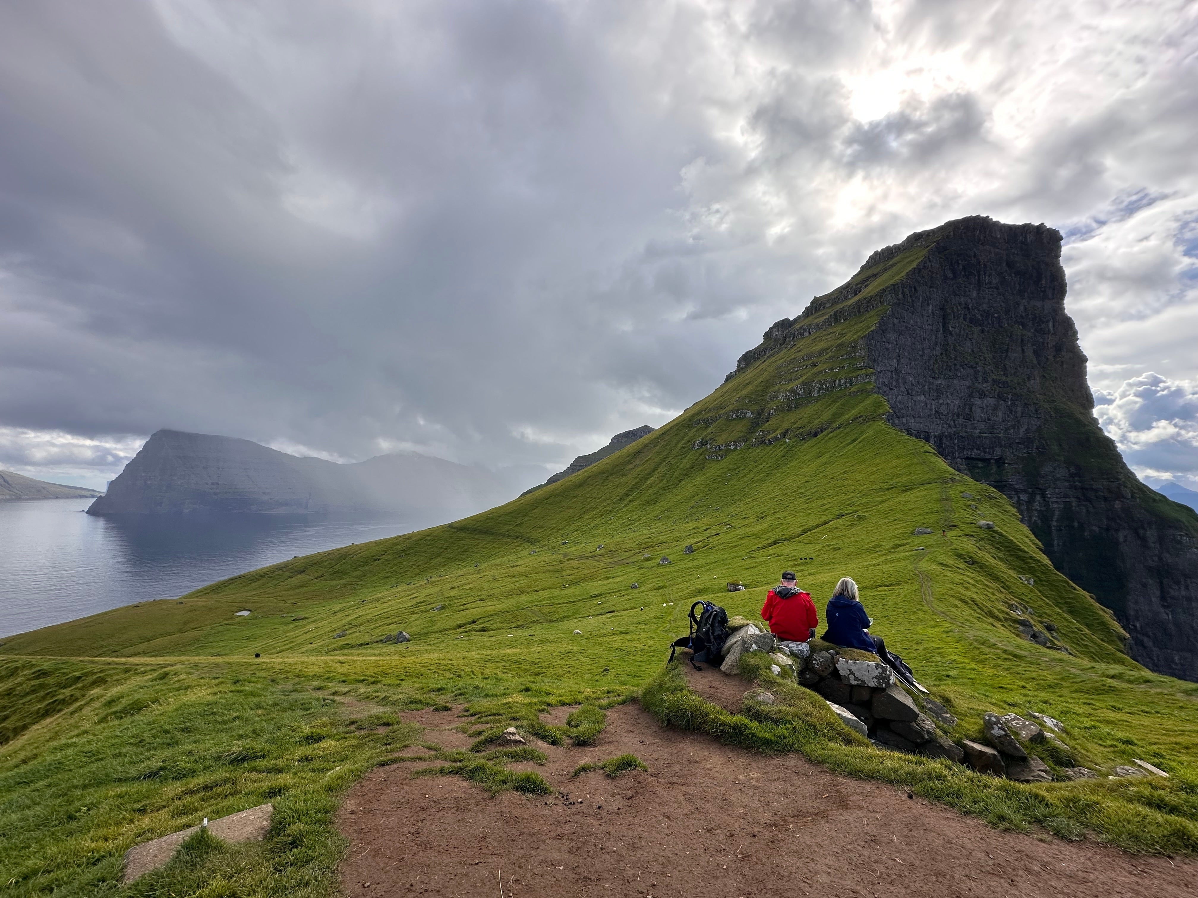 Tourists enjoy a view on Kalsoy Island at the Faroe Islands.