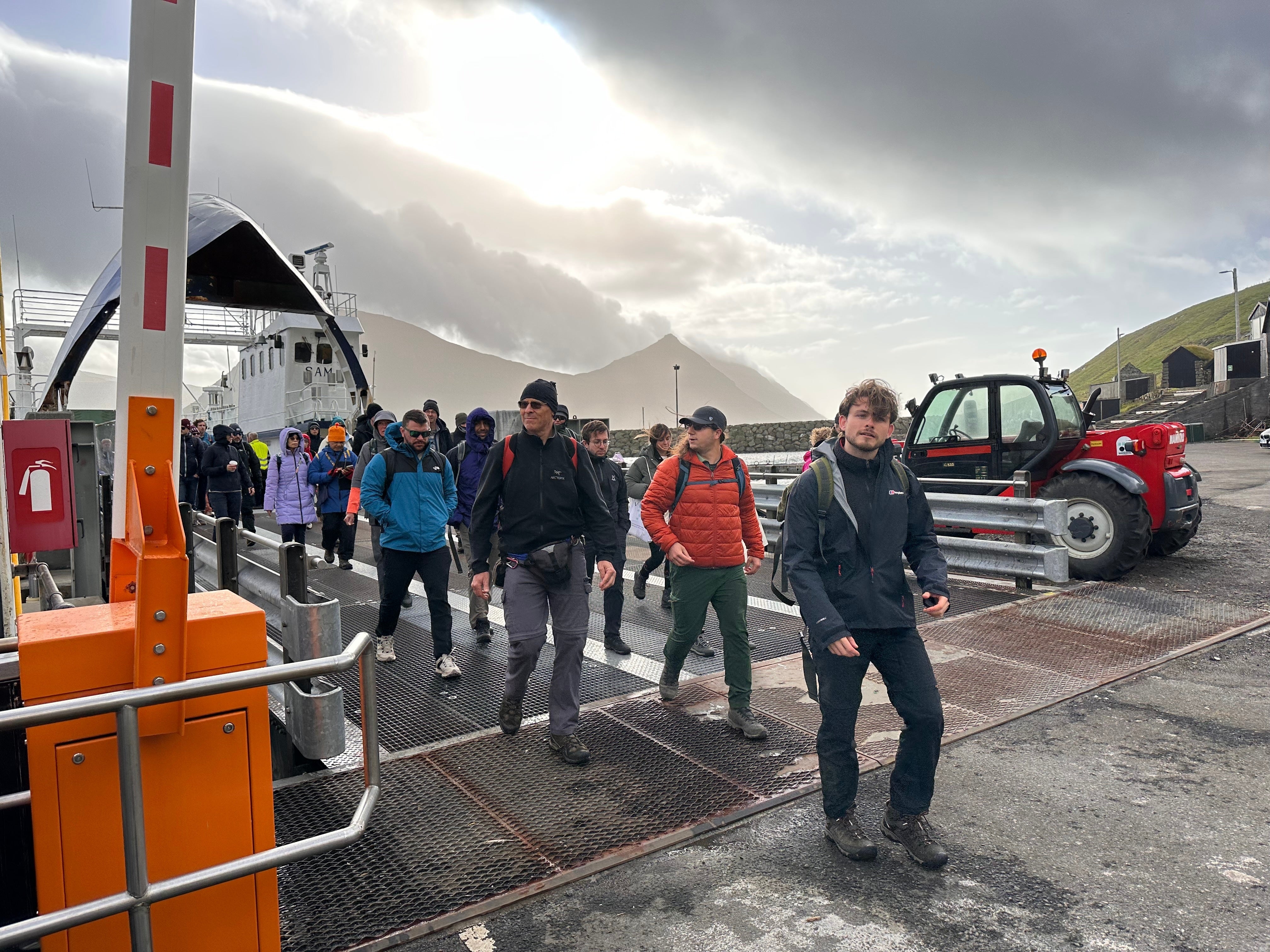 Tourists disembark from a ferry on Kalsoy Island in Faroe Islands, Sept. 8, 2025. (AP Photo/Cara Anna)