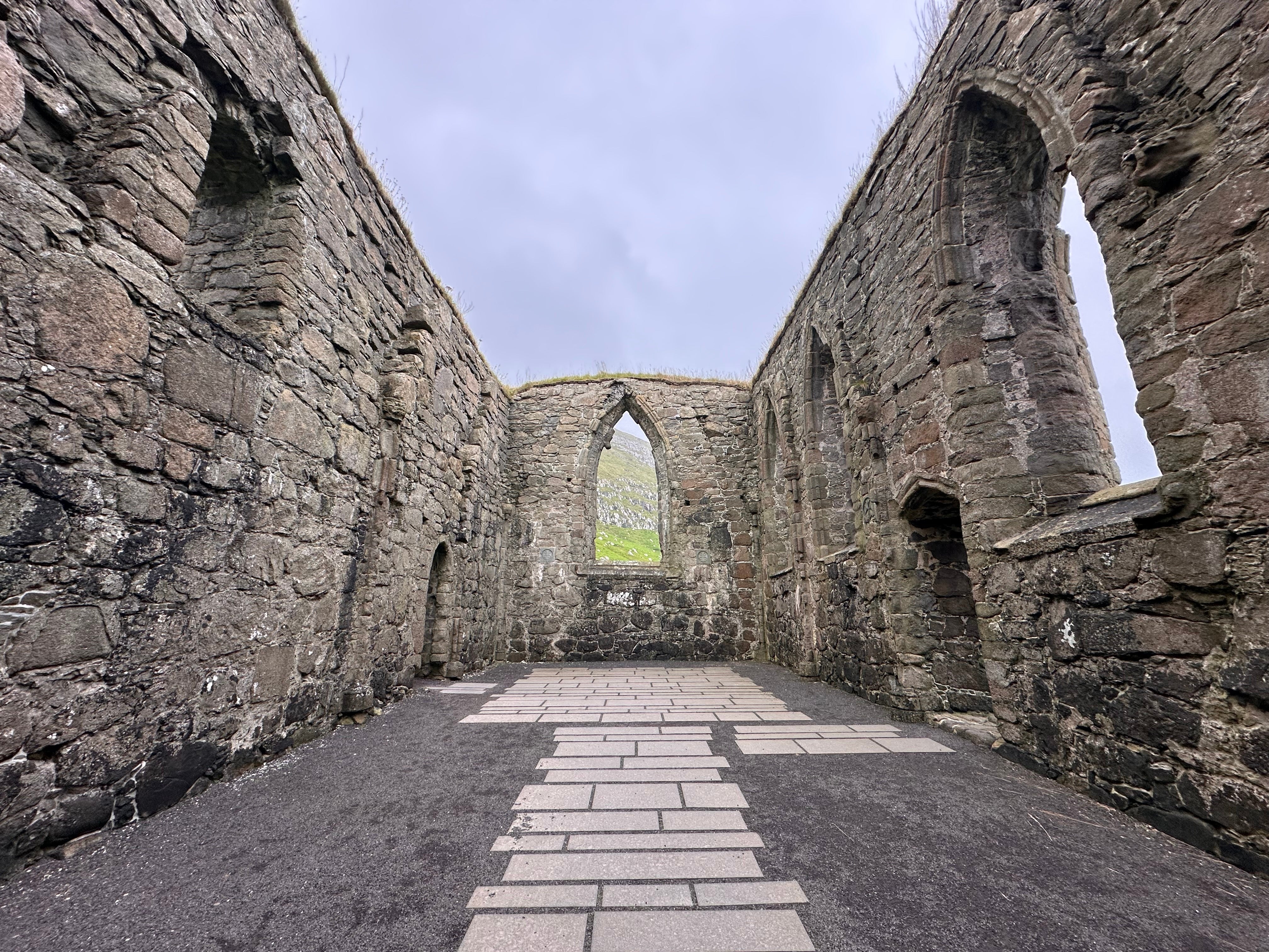 The ruins of an ancient Catholic church stand in Kirkjubour in Faroe Islands.