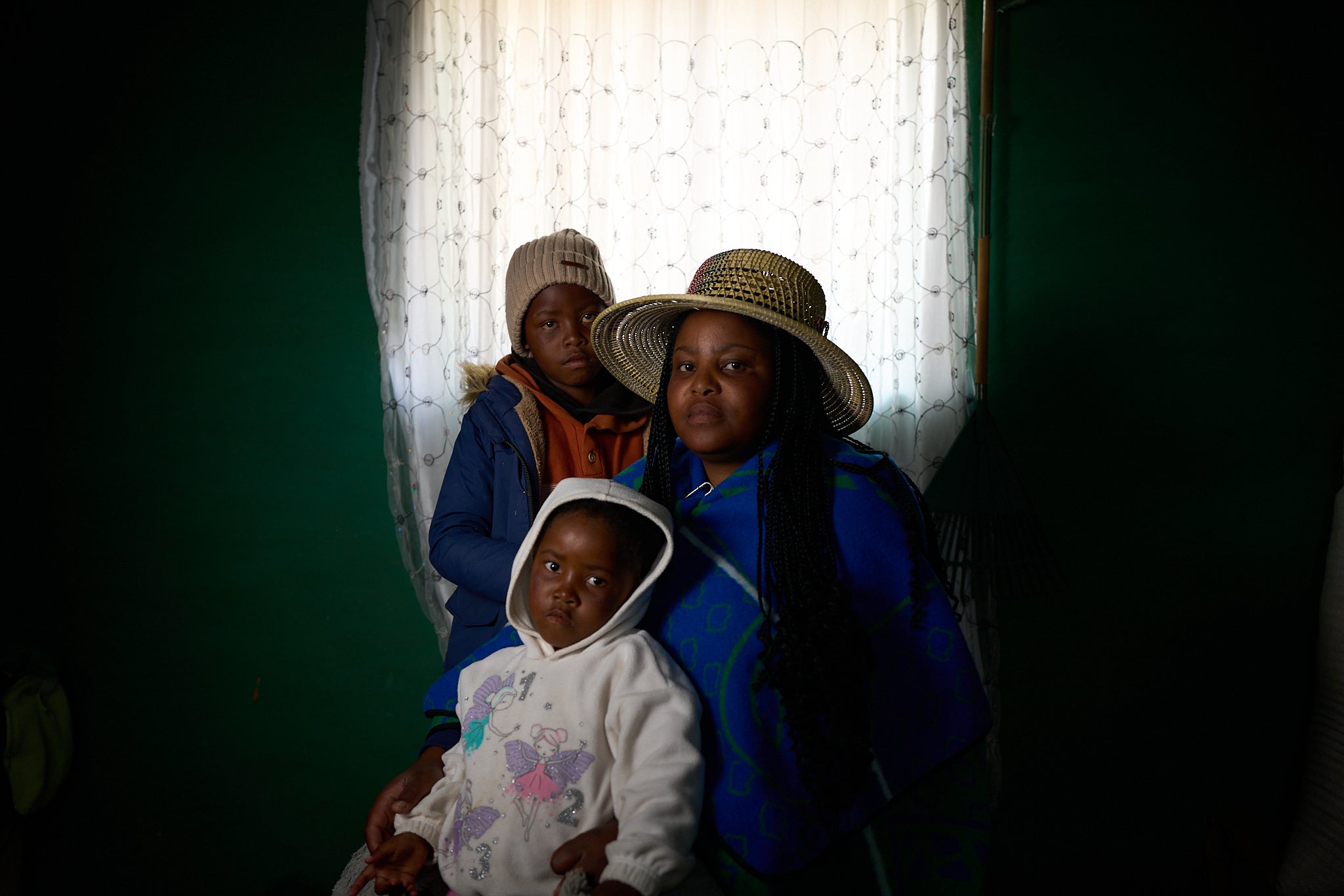Matseliso Lekhoele, 36, who is HIV-positive, with her two children, Bohlokoa, eight, and Maseabata, four, inside their home in Thaba-Tsoeu, Lesotho. Aid cuts will make medication harder to get