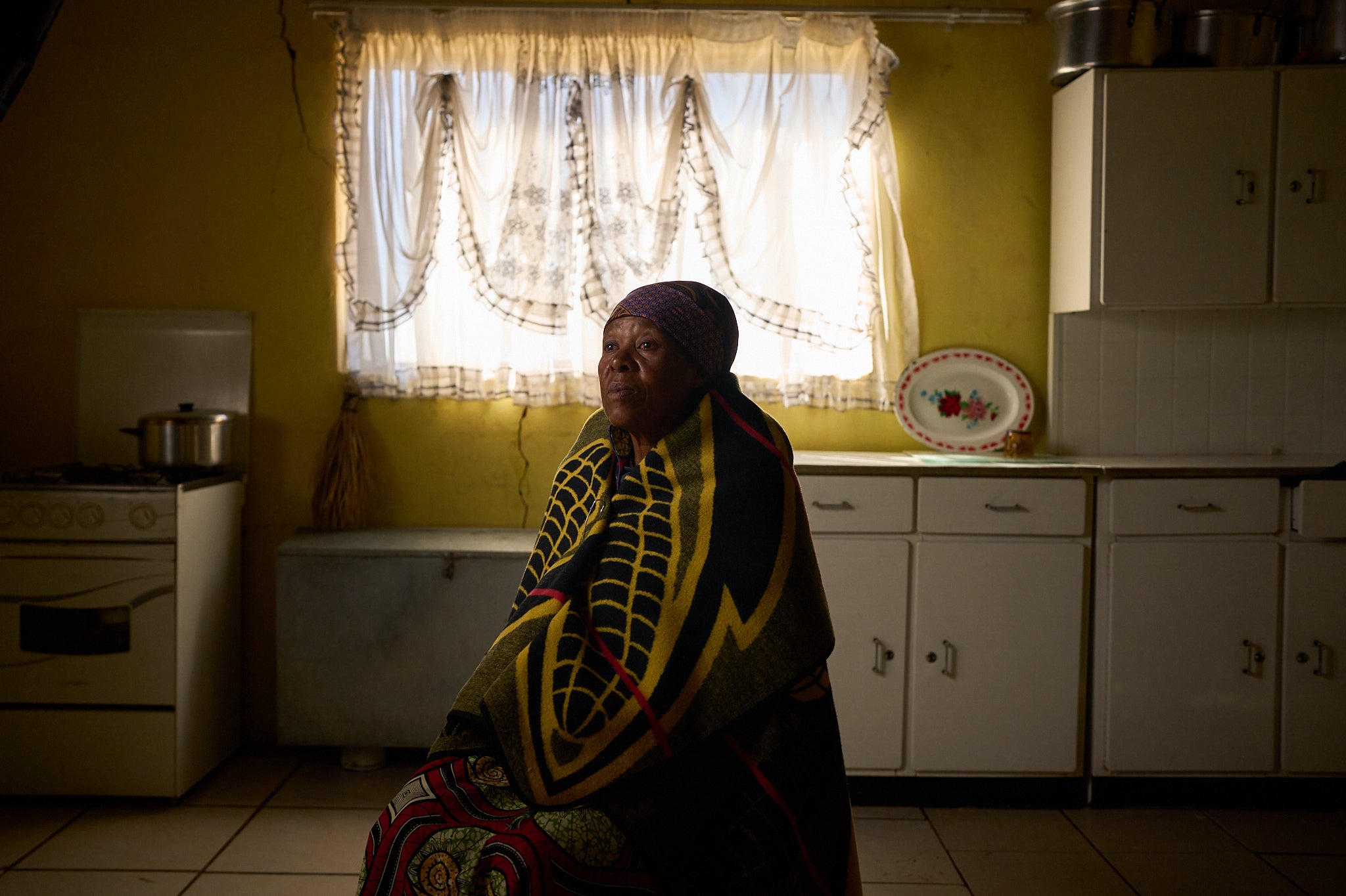 Mapapali Mosoeunyane, 62, poses for a portrait inside her home in Ha Koloboi, Lesotho, Saturday, July 12, 2025. Mosoeunyane leads a peer support group in her village. The aid cuts have caused panic among her neighbors. They remember the early days of the HIV/AIDS epidemic, when a positive test result was akin to being handed a death sentence. Lesotho has made progress in cutting deaths and infections, in large part thanks to nearly $1billion in U.S. aid. Mosoeunyane fears that with less foreign assistance, deaths and infections will rise again. (AP Photo/Bram Janssen)
