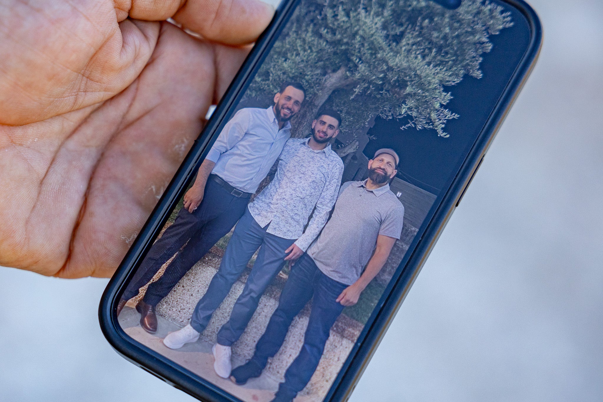 Sayf (centre) stands with his father Kamel (right) in one of the last photos taken before he was beaten to death by settlers