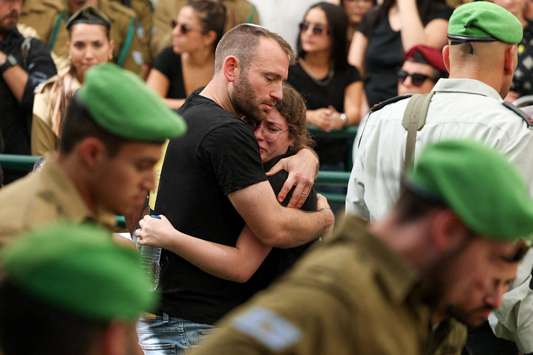 Mourners embrace each other at the funeral of Israeli captive Tamir Nimrodi, a soldier who was kidnapped during the October 7 attacks