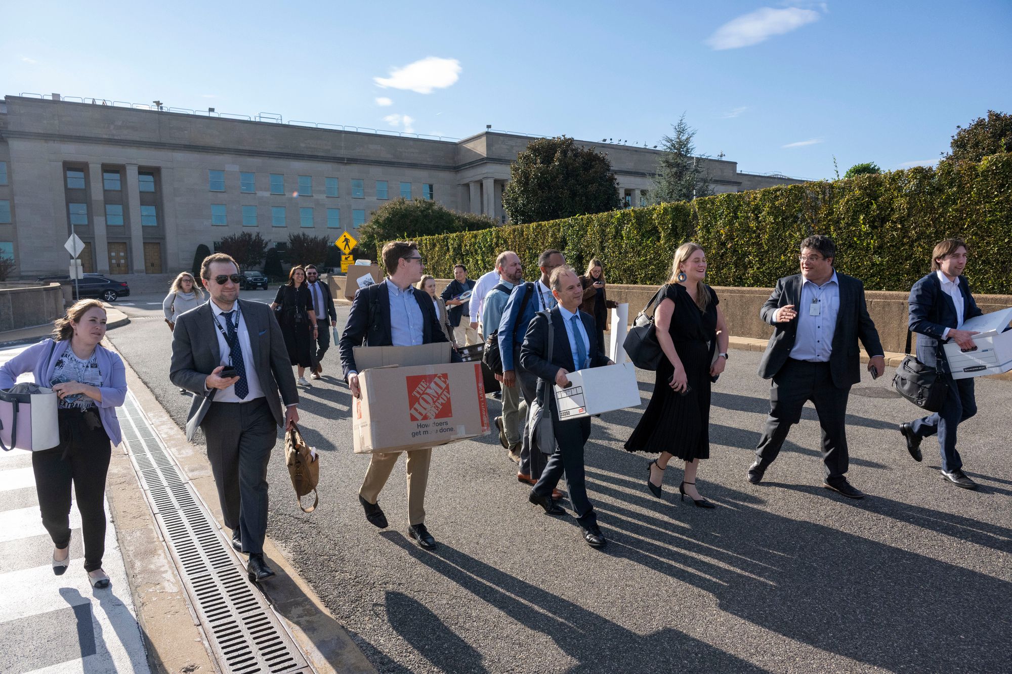 Members of the Pentagon press corp carry their belongings out of the Pentagon after turning in their press credentials this week.