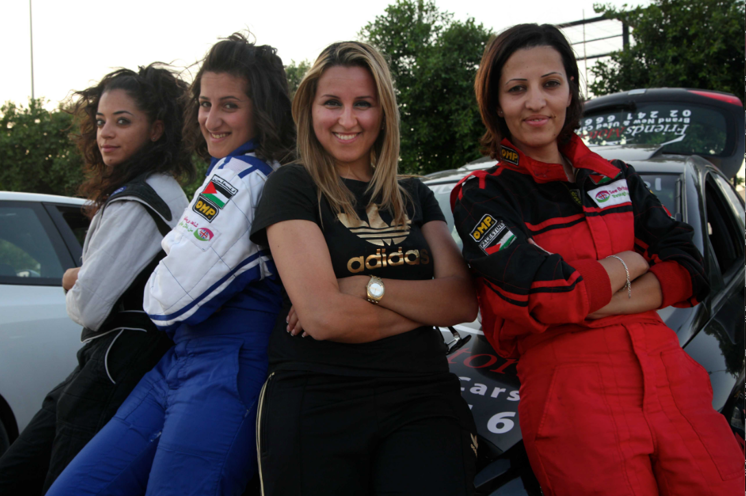 Jayussi, second right, was team manager of the Speed Sisters, who competed in Palestine's car-racing circuit