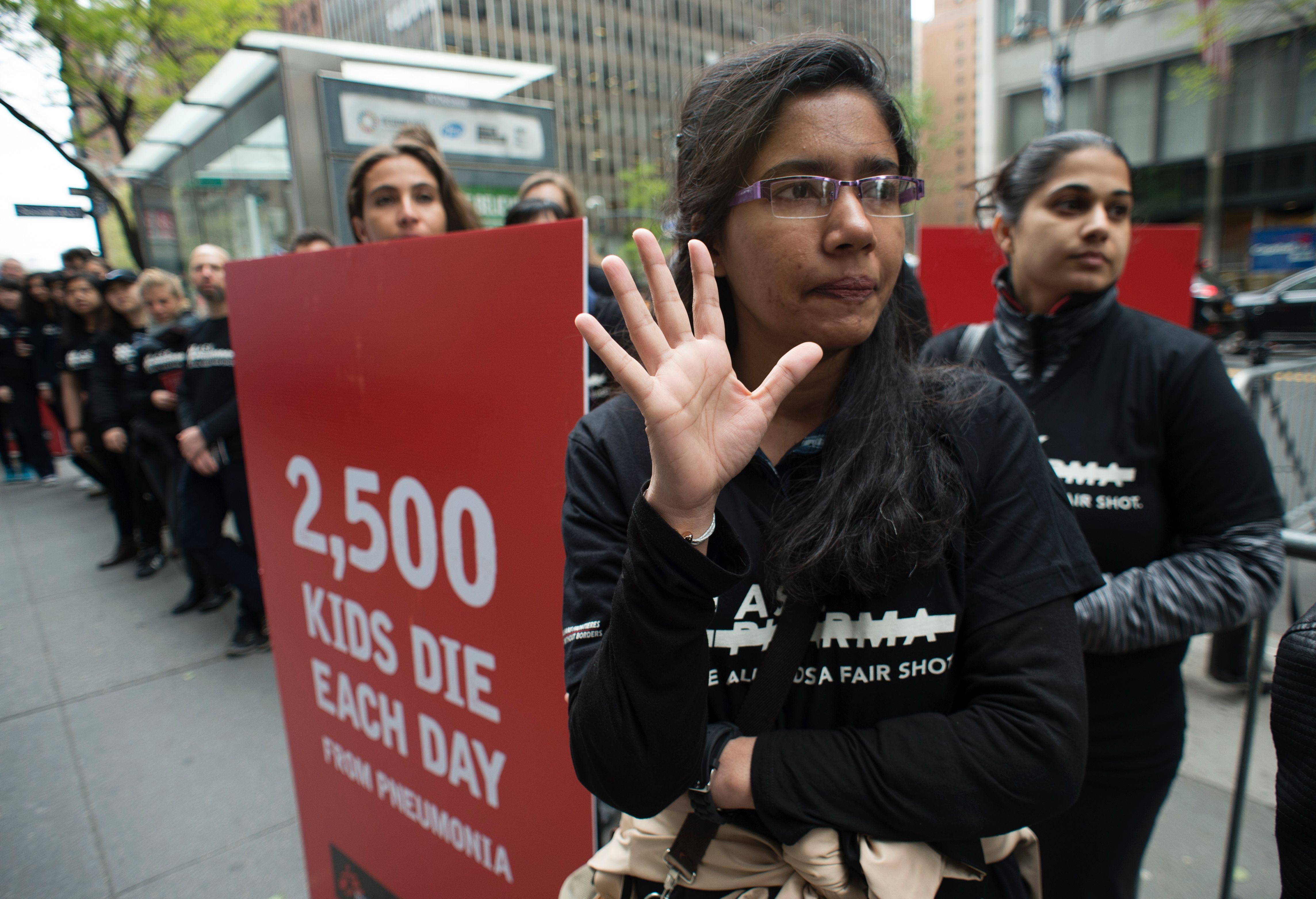 Protesters from Doctors without Borders rally in front of the Pfizer building in New York City in April 2016, demanding lower prices for pneumonia vaccines. More than 40,000 Americans die of pneumonia every year, many of whom are young children