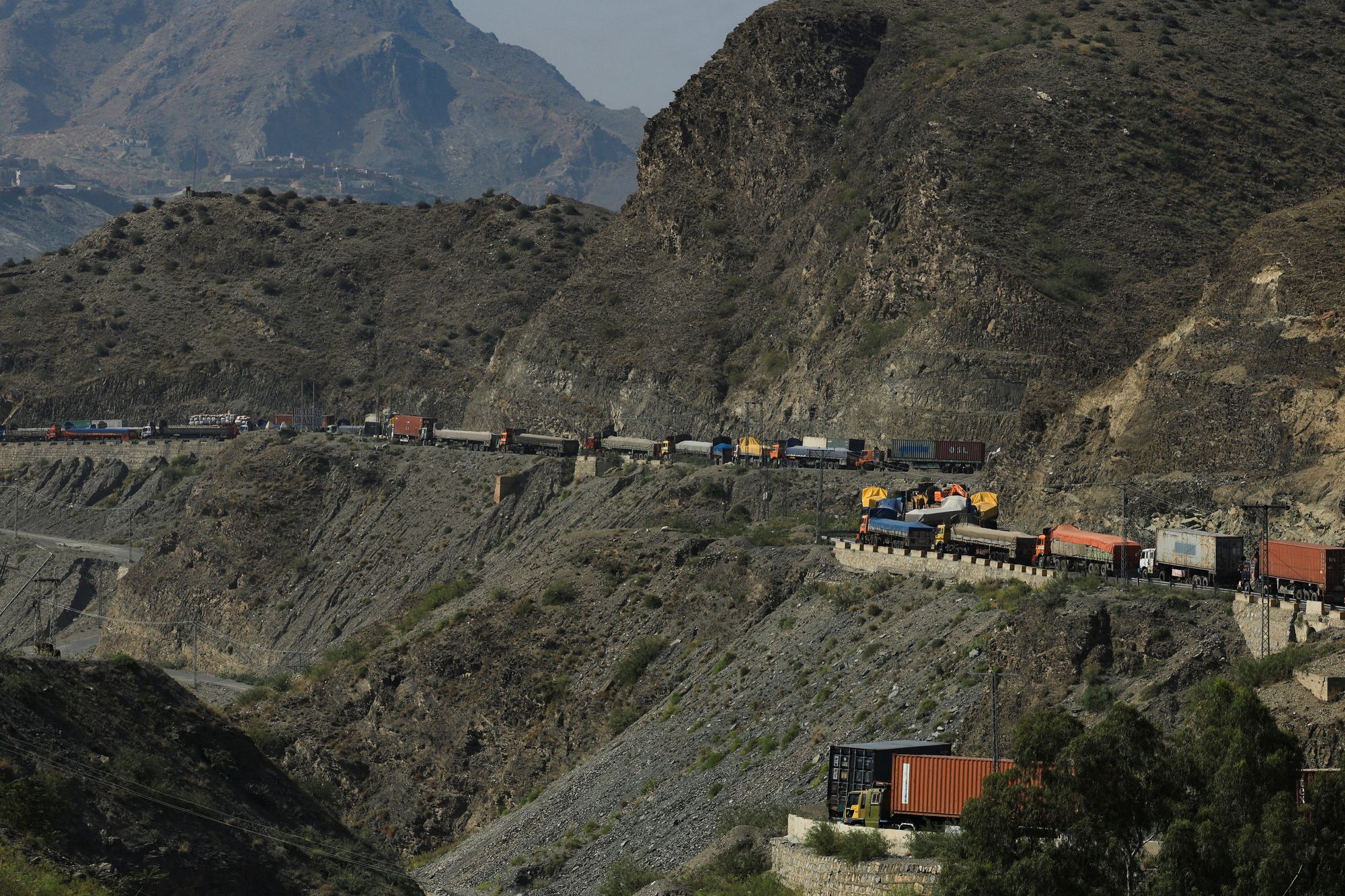 Trucks loaded with supplies park along a road leading to the Torkham border, after Pakistan closed border crossings with Afghanistan, following exchanges of fire between the two nations' forces, in Torkham, Pakistan, 15 October 2025