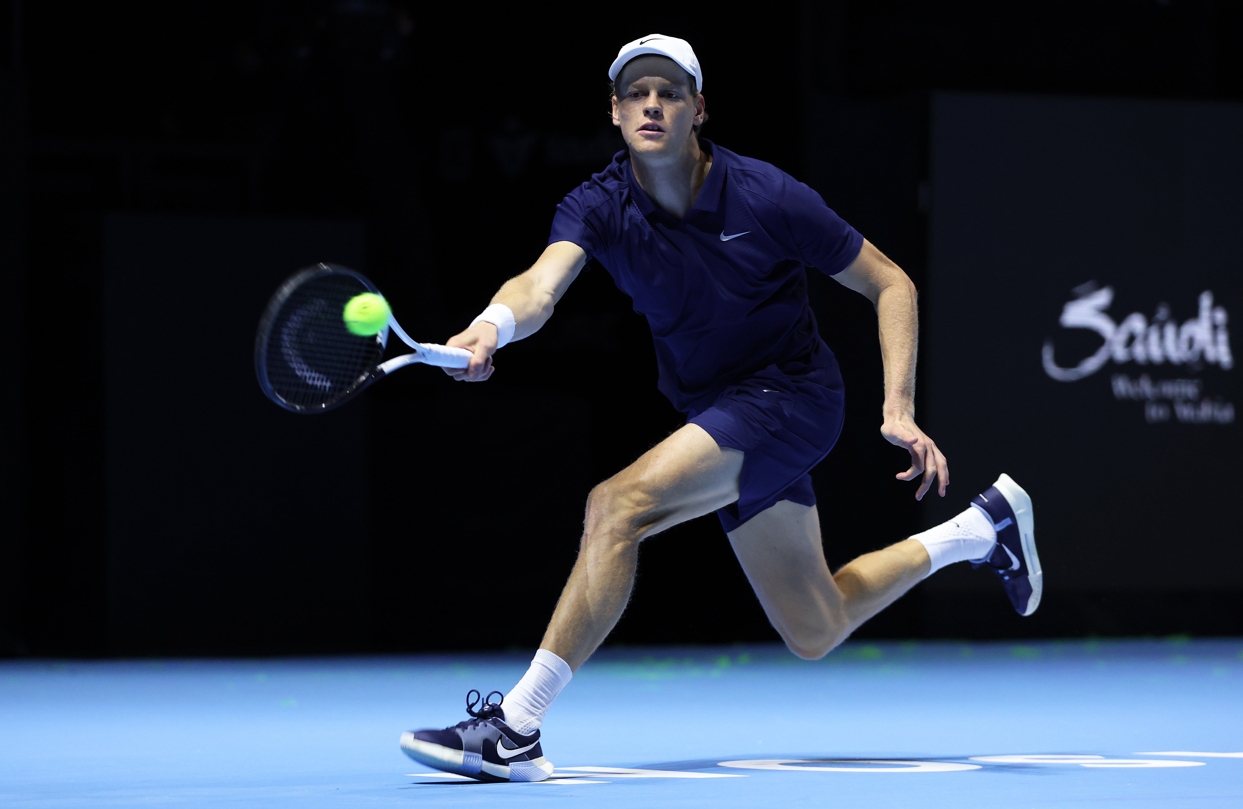Jannik Sinner of Italy plays a forehand against Stefanos Tsitsipas of Greece in their quarterfinal