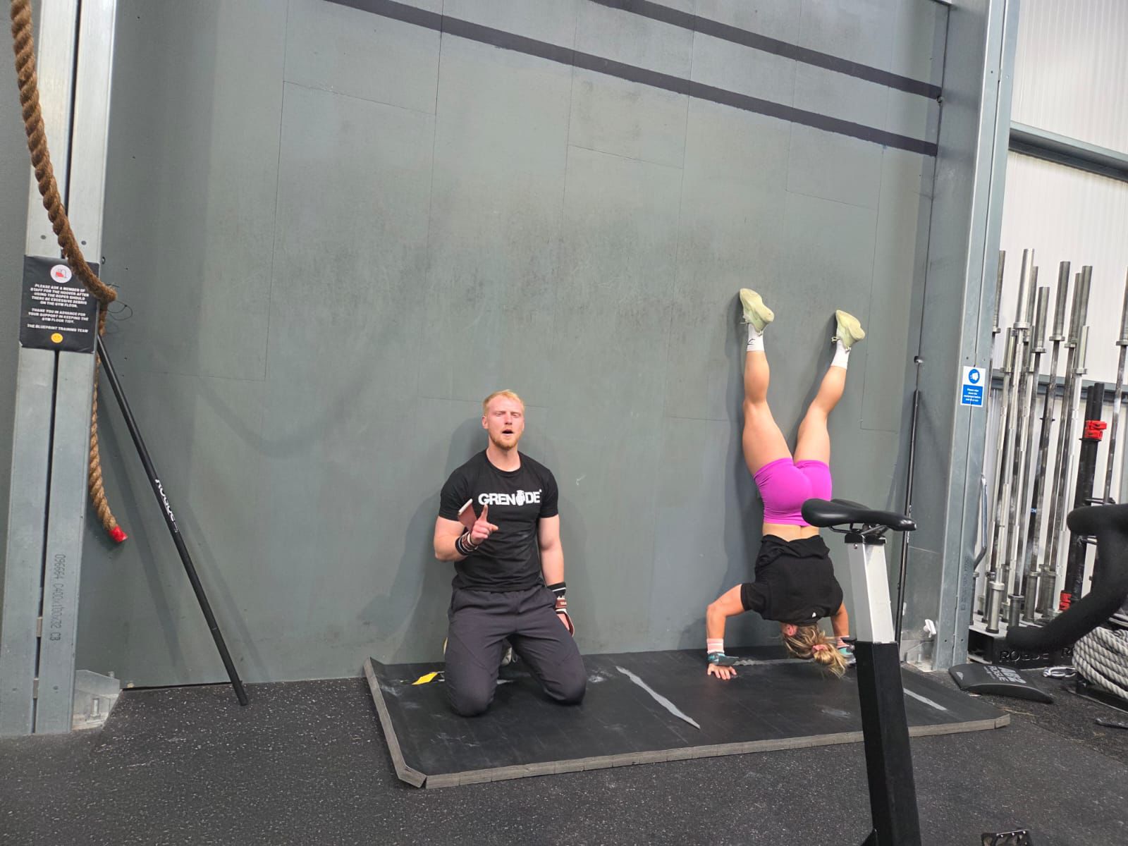 I have to scale back my handstand press-ups as Cringle breezes through her set next to me