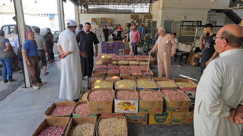 Farmers and traders at the Aleppo pistachio market share their concerns about declining yields and rising costs