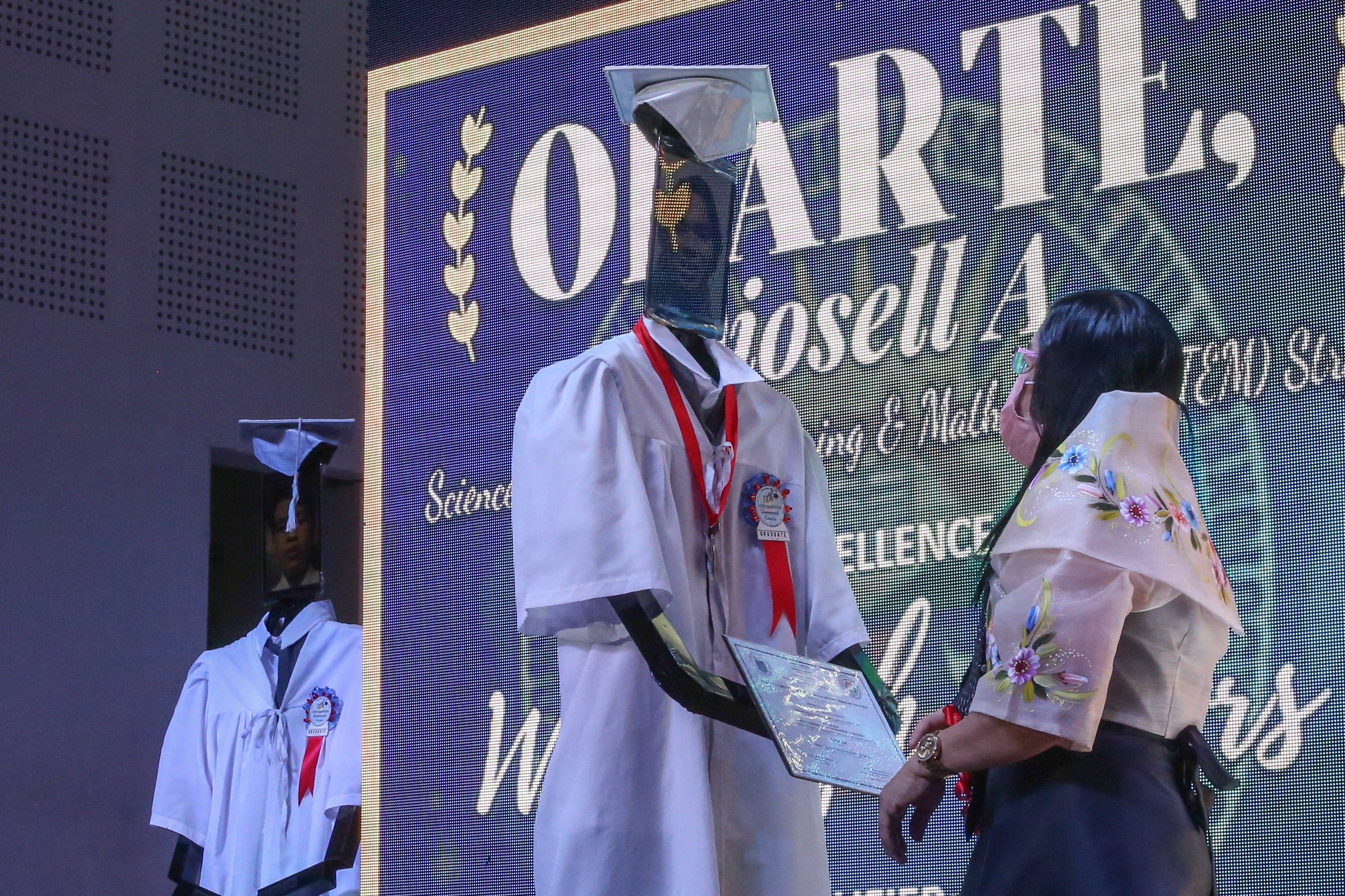 A robot stands in for an outgoing high school student at a 'cyber graduation' ceremony during the the height of the pandemic in Manila in the Philippines — a foretaste, perhaps, of the future of the job market