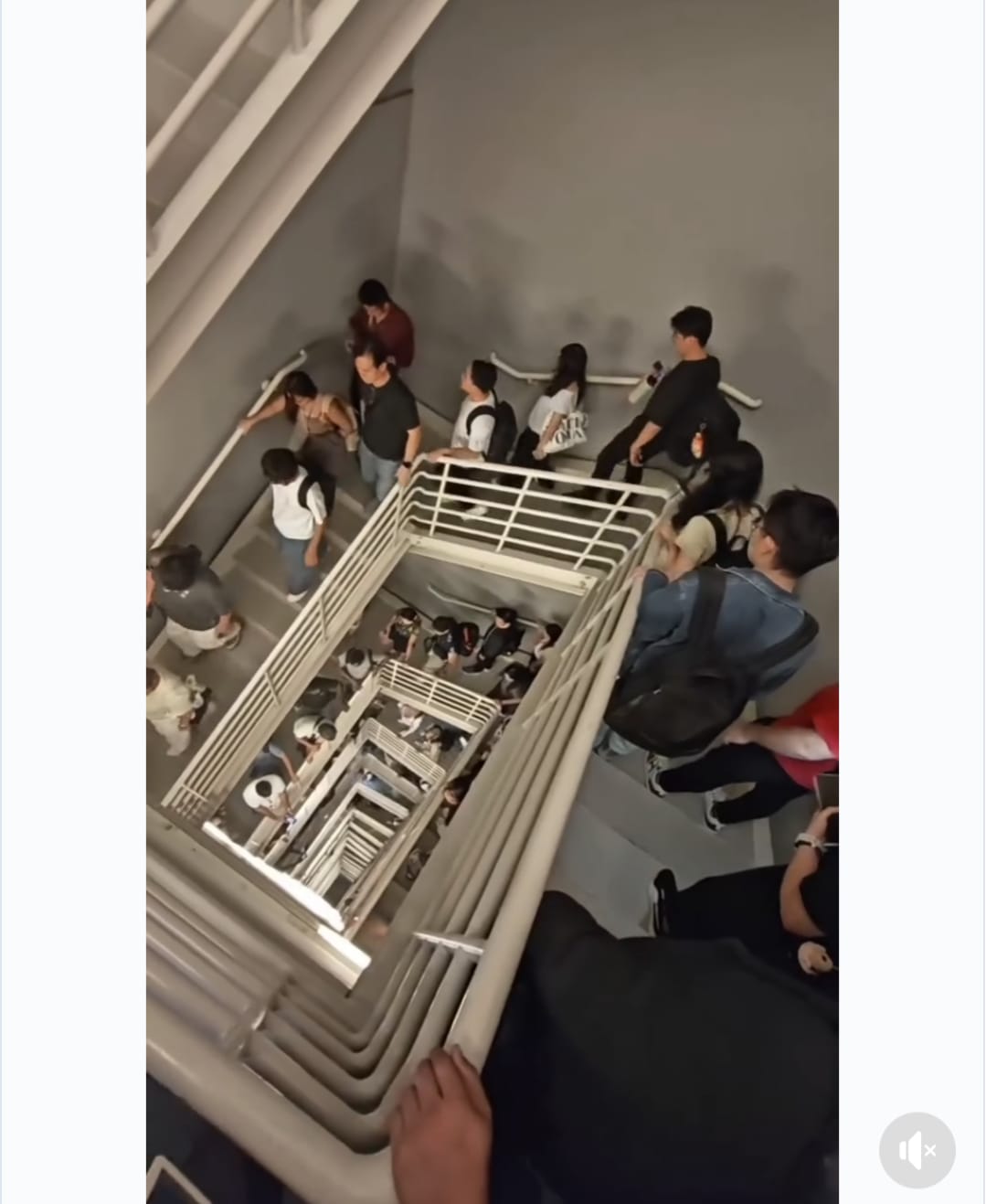 Workers walk down a flight of stairs as lifts stop working in one of the tallest buildings in Malaysia