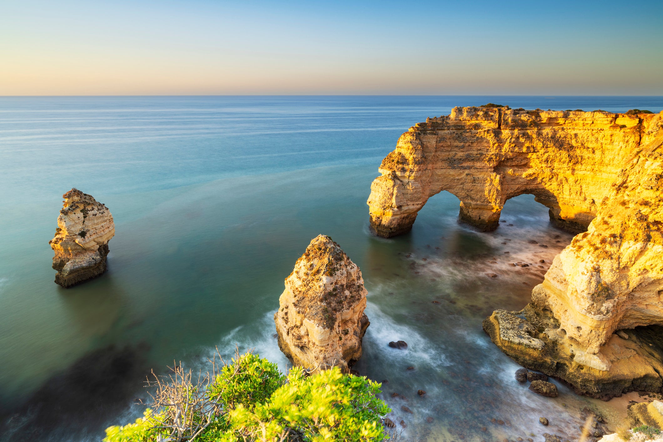 A double-arch rock formation helps make Praia da Marinha one of Portugal’s most photogenic beaches