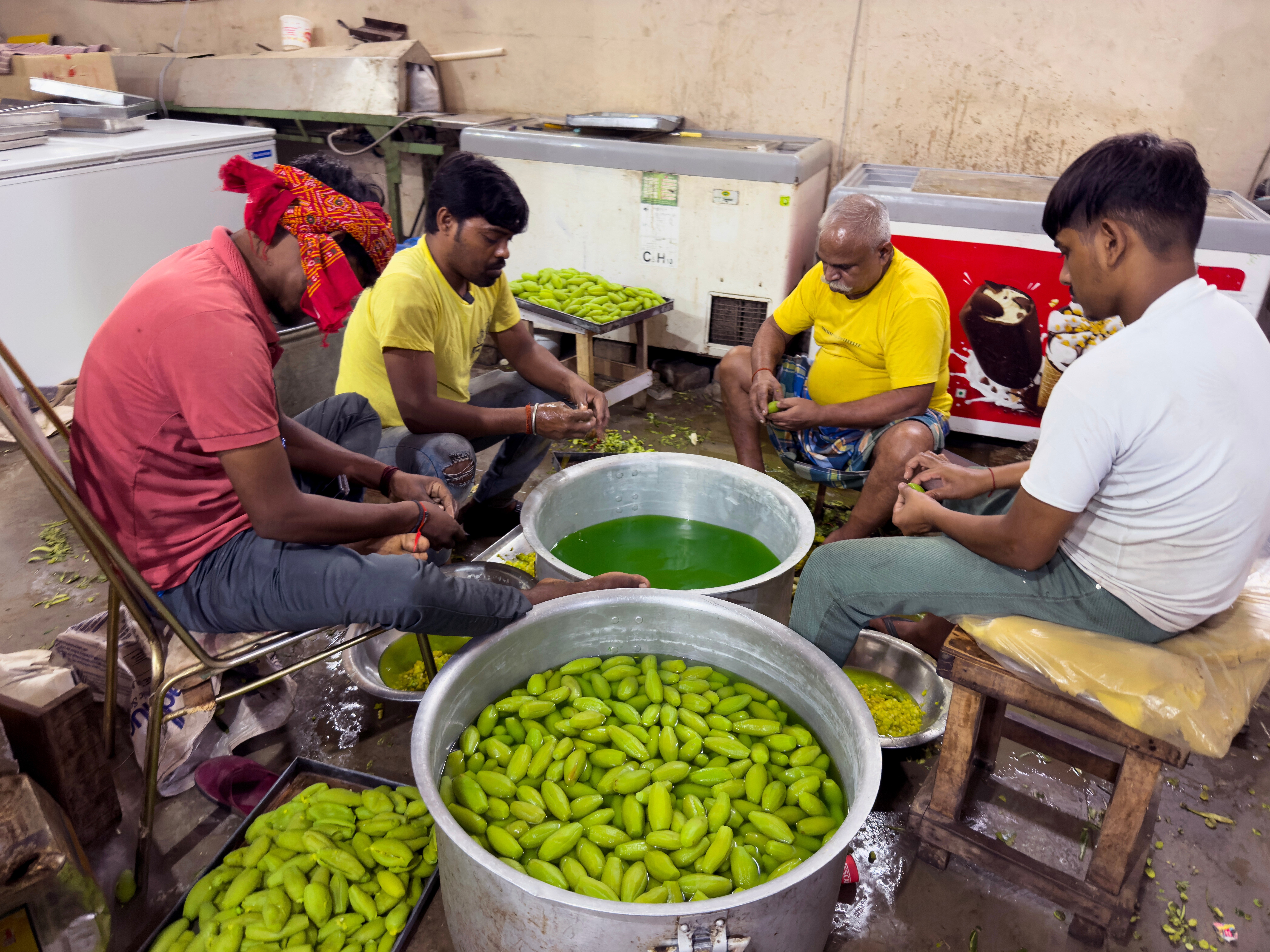 Workers making sweets at factory for Diwali, the festival of lights, in Chilbila Pratapgarh District, northern Indian state of Uttar Pradesh.